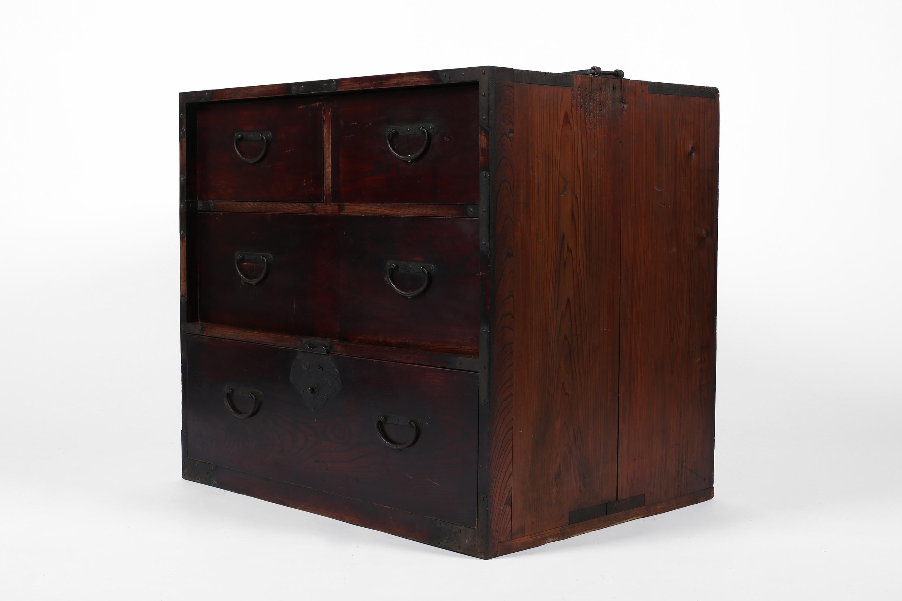 An unusually deep & heavy Meiji period tansu chest constructed from patinated stained elm timber with forged iron hardware. Two small hidden drawers to the top right can be removed to reveal a further two secret compartments within. Original locking