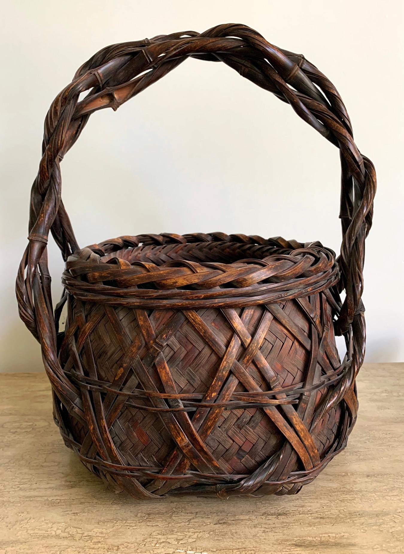 Bold, rustic and with an earthy free spirit, this wagumi style flower basket with twisted handle (ikebana) was designed and woven to evoke a sense of serenity and humbleness during the tea ceremony. With a large and solid barrel shape that evokes a