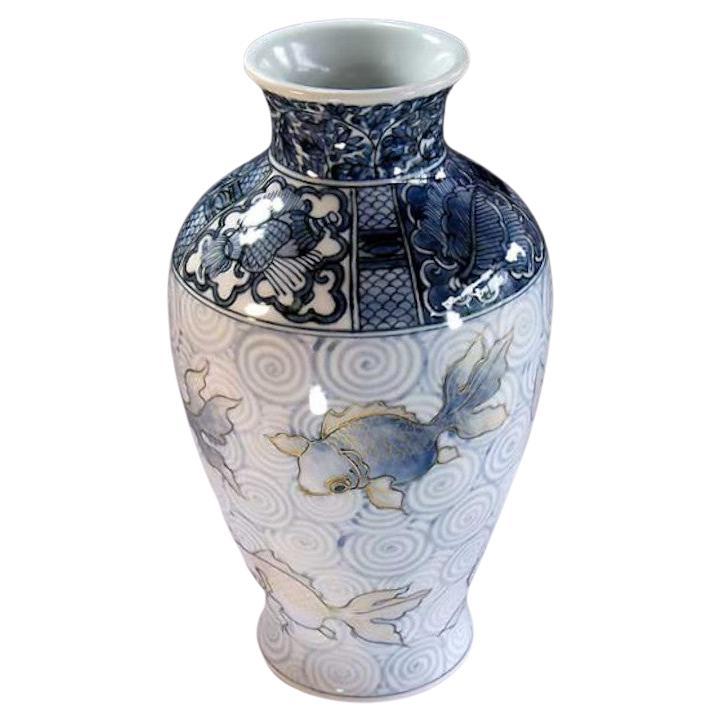 Japanese contemporary decorative porcelain vase, hand painted in beautiful shades of blue underglaze on an elegantly shaped porcelain body, a signed piece from the artist's signature golld fish collection by widely acclaimed Japanese master