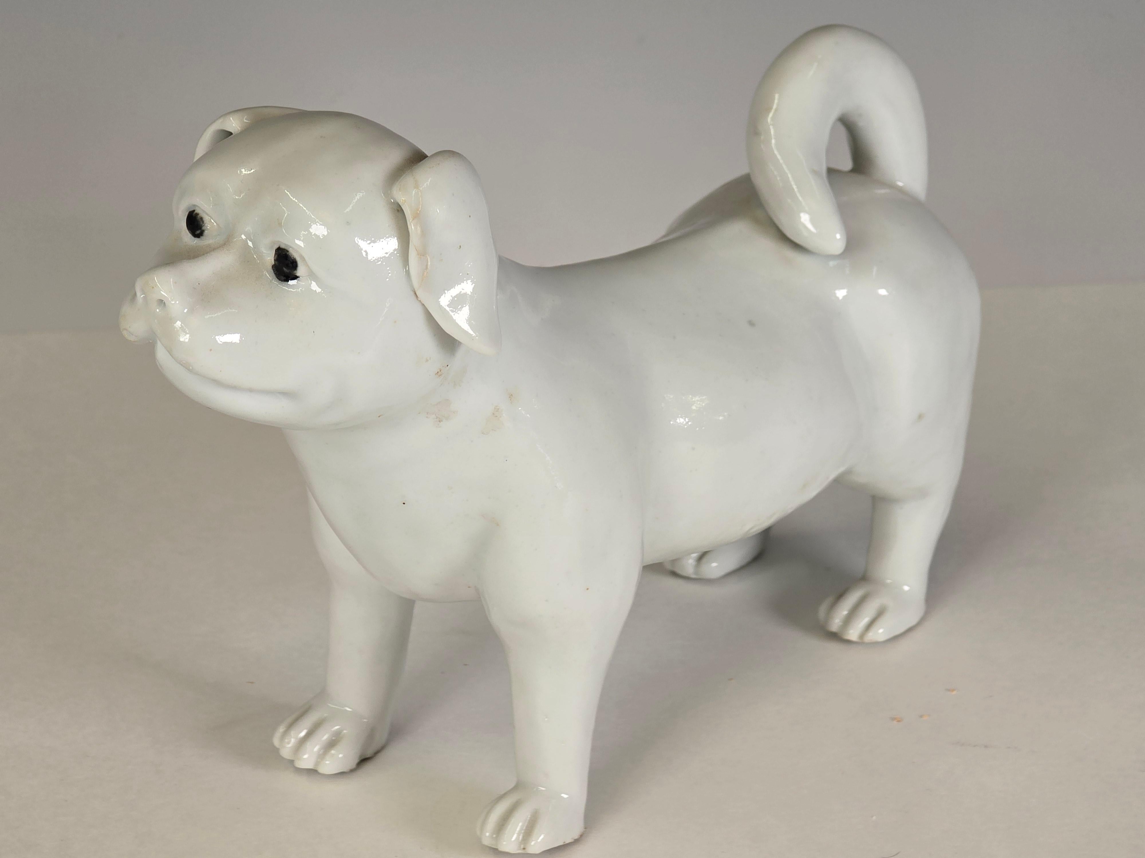 An adorable Japanese Hirado Mikawachi ware porcelain model of a dog with clear glaze over bright white porcelain    Edo to Meiji period, early to mid 19th Century.   This adorable puppy is portrayed in a standing position with tail raised above it's