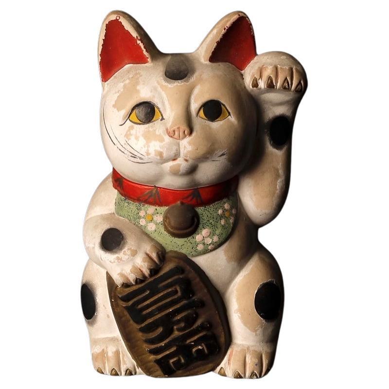 What is the story behind the Japanese cat?