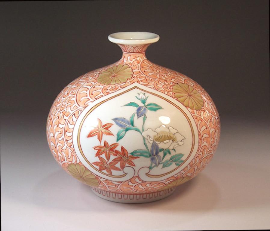 Exquisite contemporary Japanese porcelain decorative vase, intricately hand painted in pink, white and blue on an elegantly shaped body, a signed work by highly acclaimed Japanese master porcelain artist in Imari-Arita tradition of Japan. He has