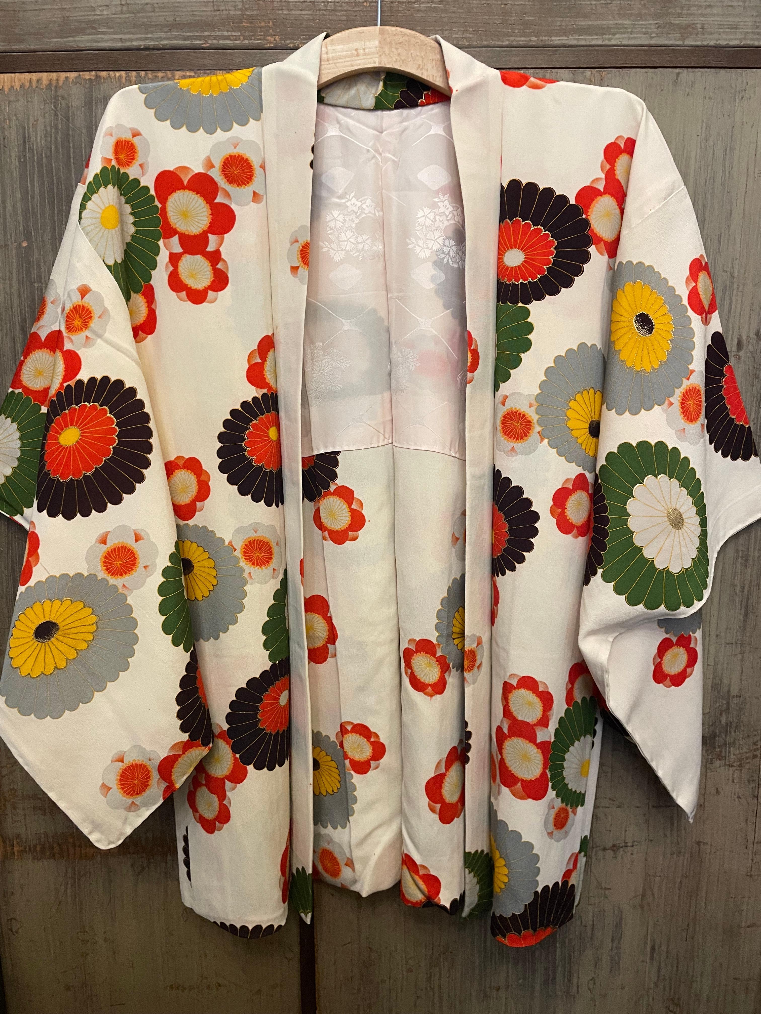 This is a silk jacket which was made in Japan.
It was made in Showa era around 1980s.

The haori is a traditional Japanese hip- or thigh-length jacket worn over a kimono. Resembling a shortened kimono with no overlapping front panels (okumi), the