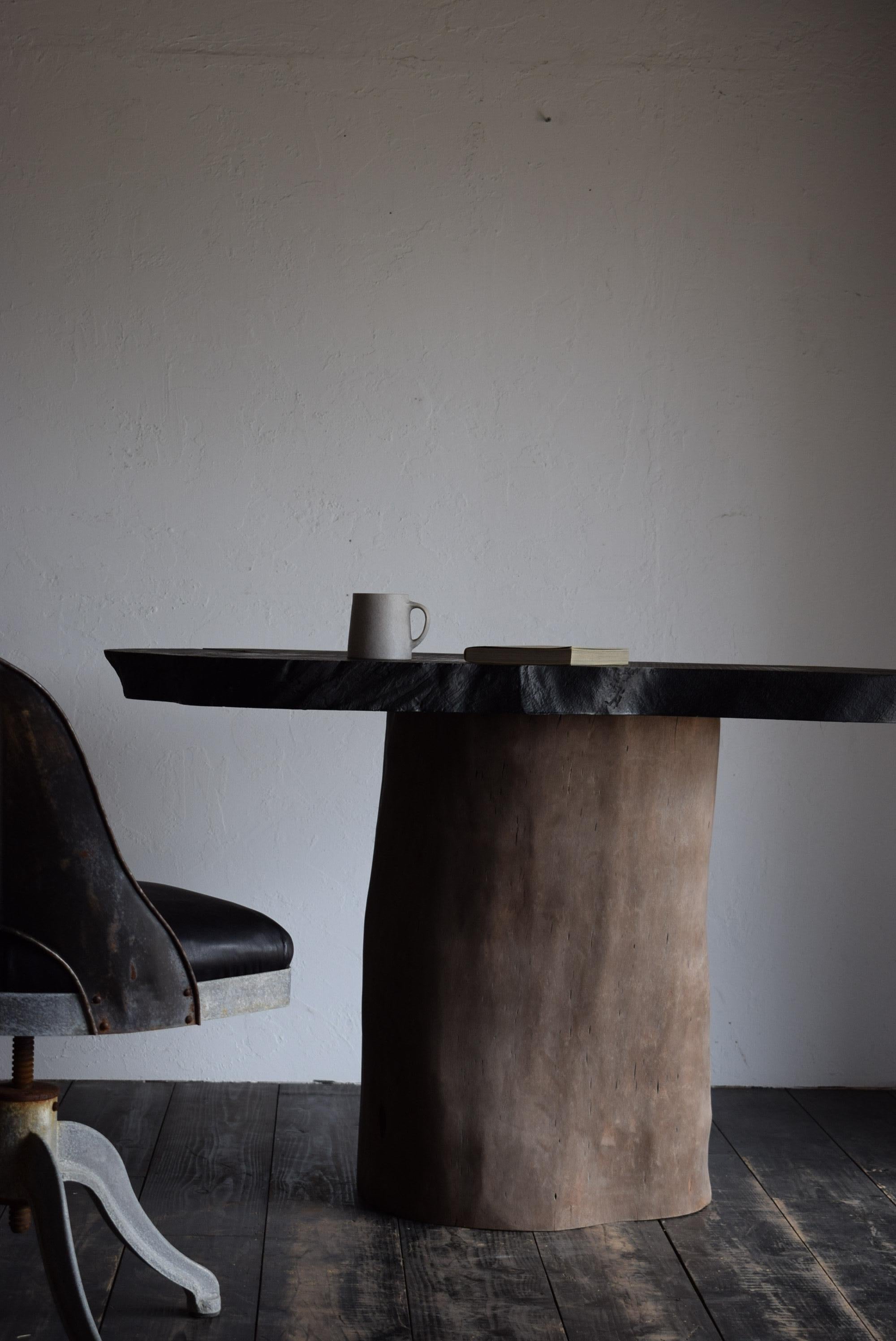 The table is made from a single piece of Zelkova wood with a base made from a stump cut in half.

The tabletop is made of a single piece of keyaki wood that has a natural shape and is firmly fixed to the stump that serves as the base.
The tabletop