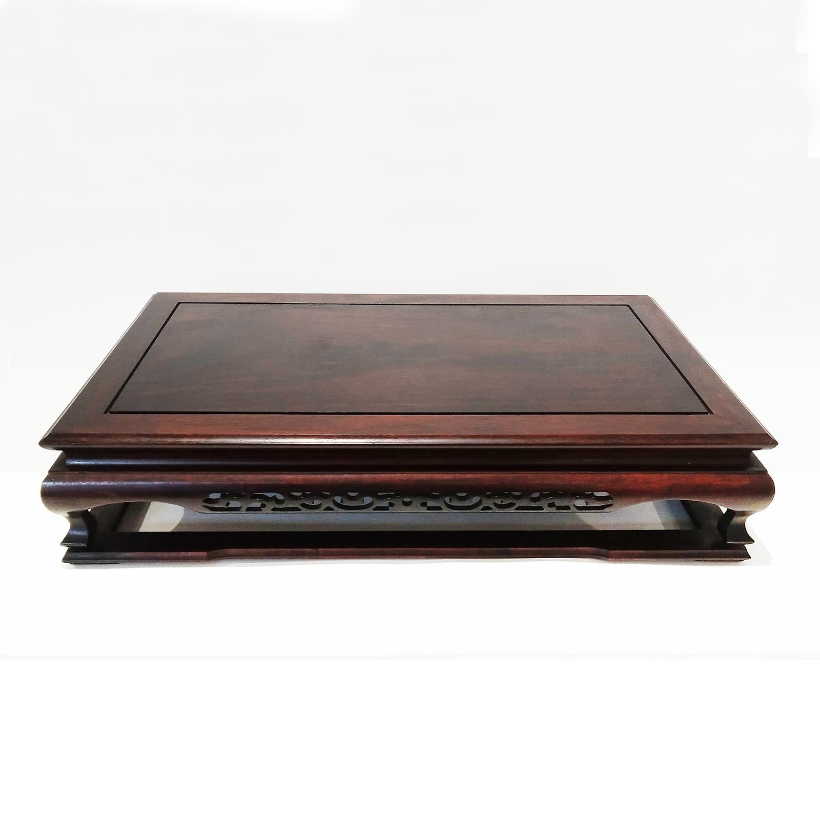 A small, beautifully preserved tray table, hand-carved in teak and stained in rich dark brown. Japan, Meiji period (1868-1912). 5 inches high, 22 inches wide, 13 inches deep. Original finish. 