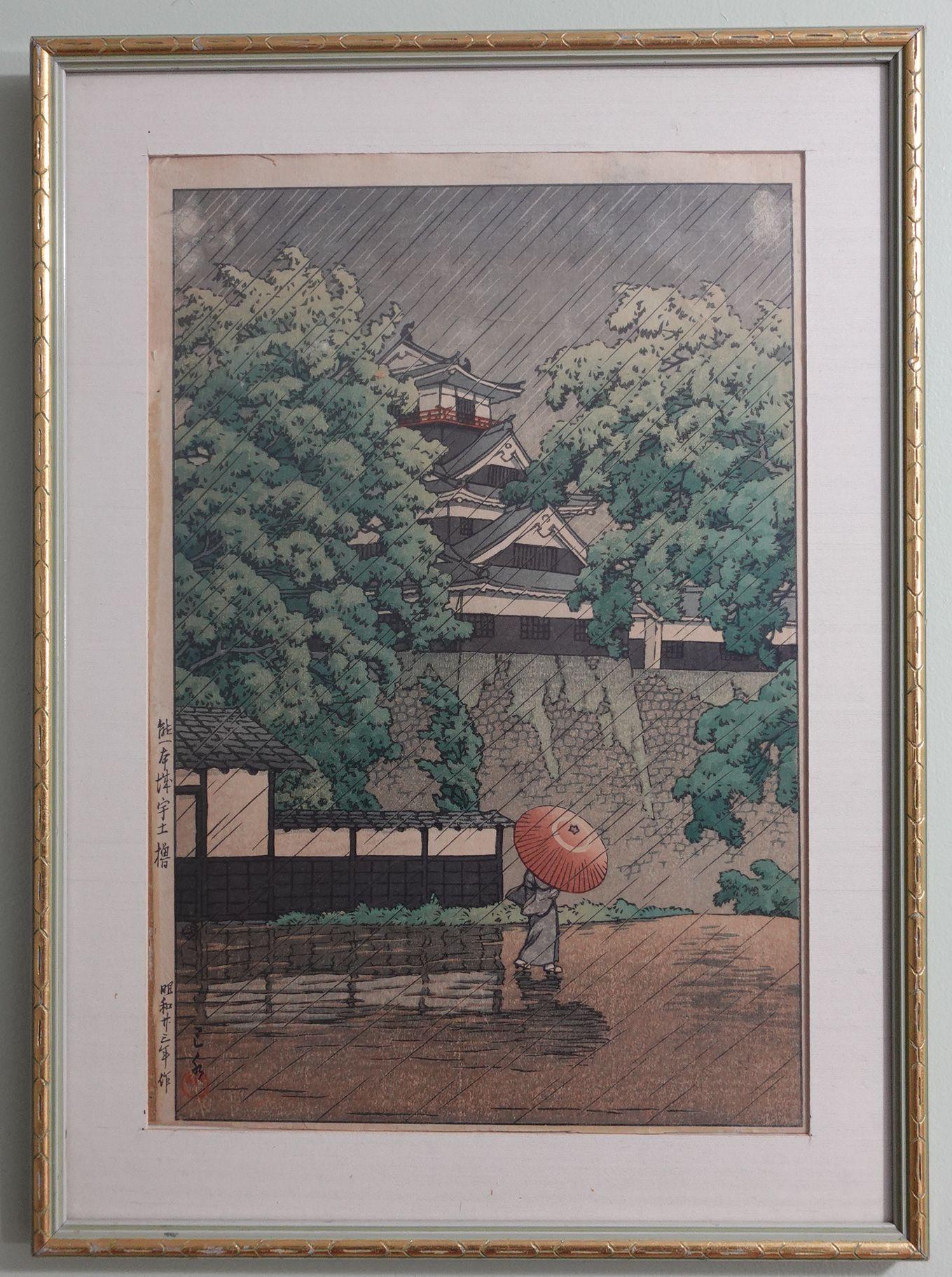 This woodblock depicts a figure caught in a rainstorm, carrying an umbrella outside a palace wall, sheet size 15 inches x 10.25 inches (38 x 26 cm)

About the artist
Hasui Kawase’s (1883-1957) prints are characterized by their serenity of mood