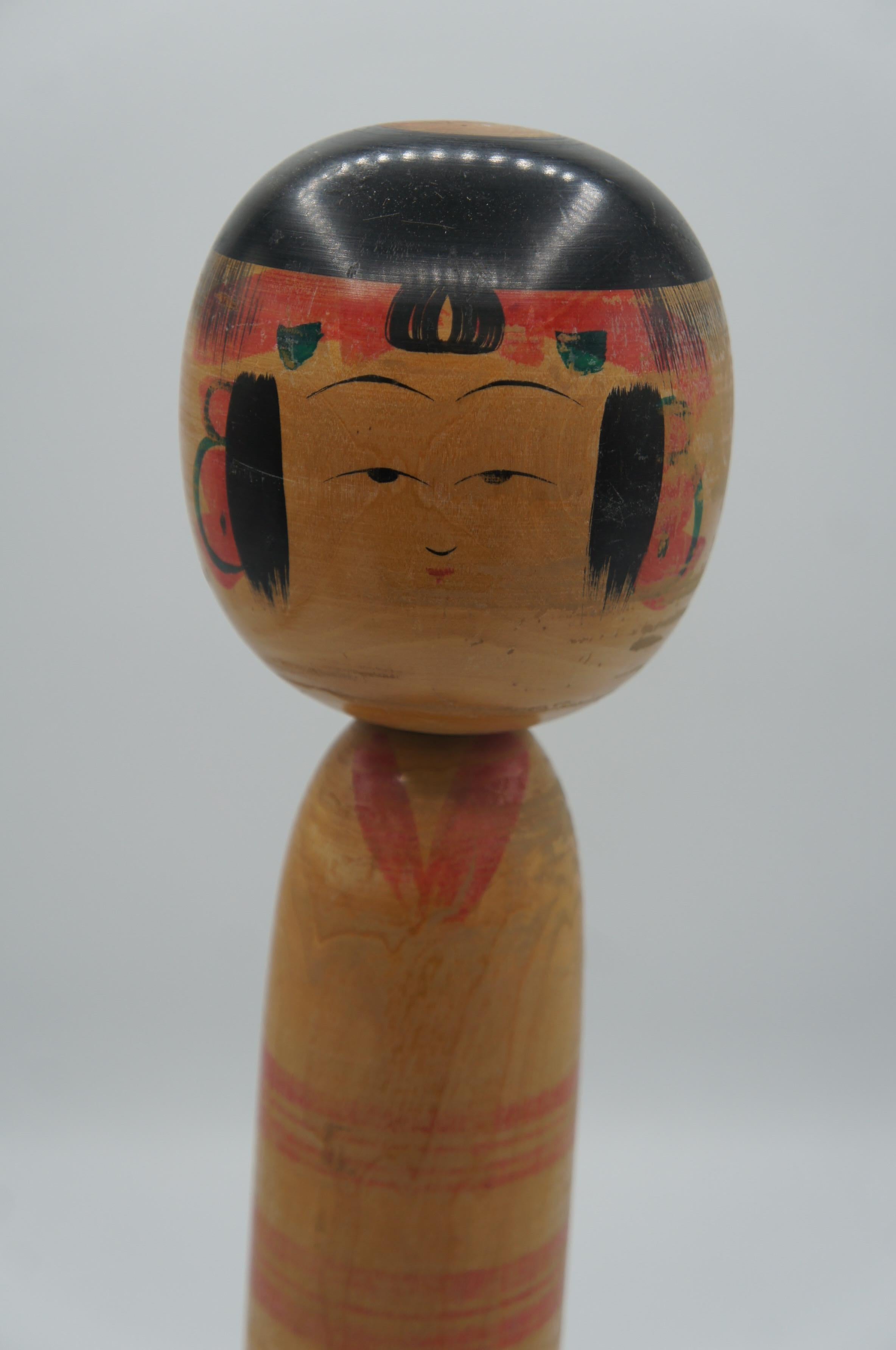 This wooden doll is called Kokeshi in Japanese. 
This kokeshi was made by a kokeshi artist Sakyo NIIYAMA. He was born in 1934, 18th March.
 It is made with Yajiro style from Miyagi prefecture in Tohoku.

Dimensions: H36 x 10 x 10 cm

Kokeshi are