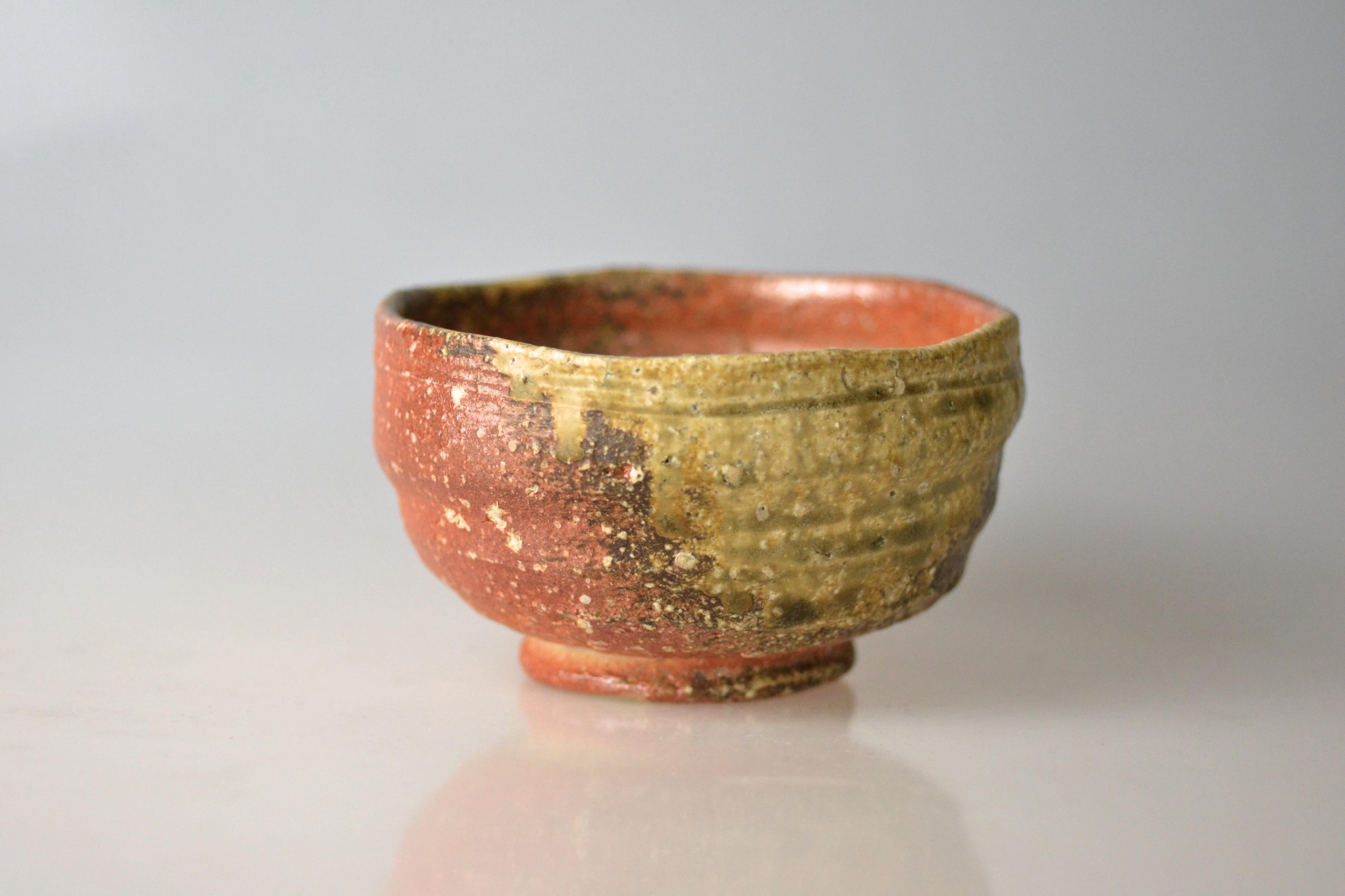 Traditional, hand-thrown tea bowl for matcha with ash glaze from wood firing. Takahashi Rakusai IV (1925) is one of Japan's grand masters of traditional pottery who specialized within his family business on Shigaraki ware. Shigaraki ware is sandy