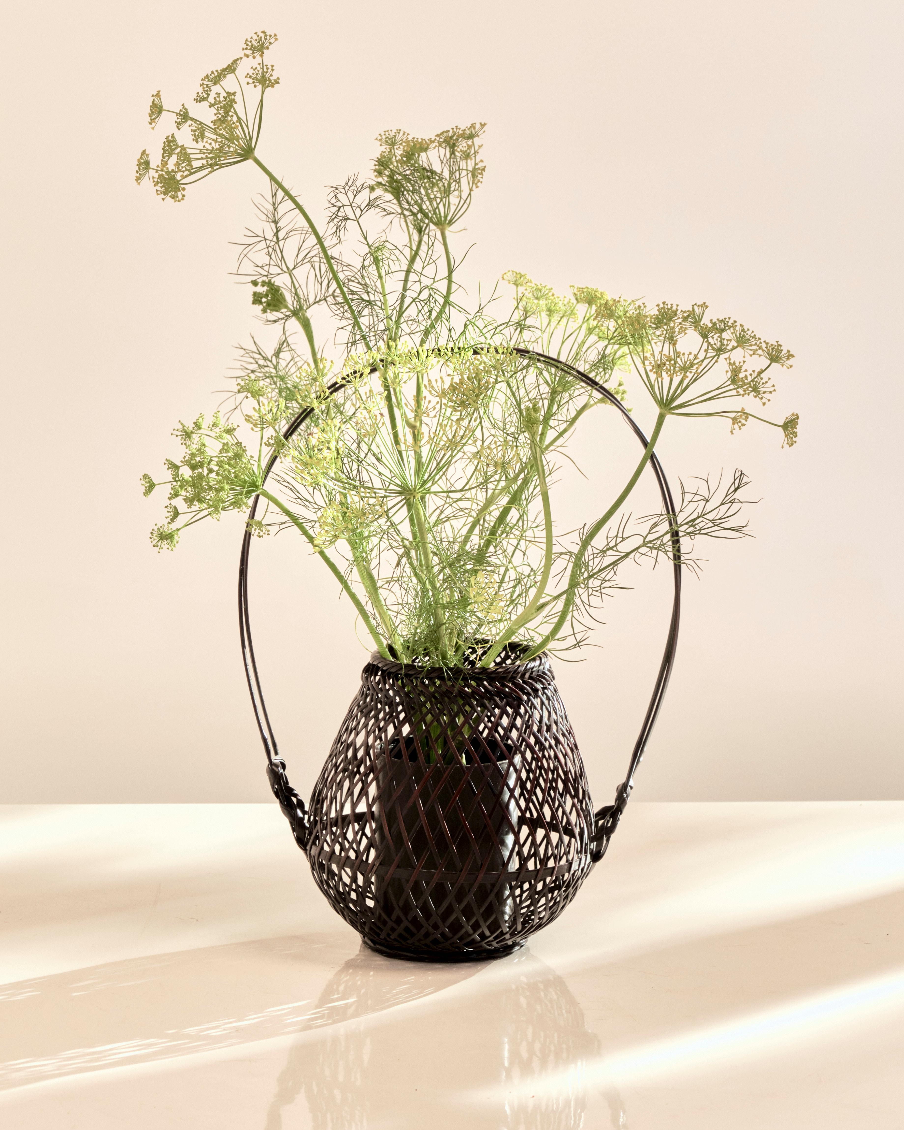 1920s, Japan. Woven Bamboo Flower Basket. Large Sculptural Looped Handle. Vase insert piece for holding florals. In great condition.
