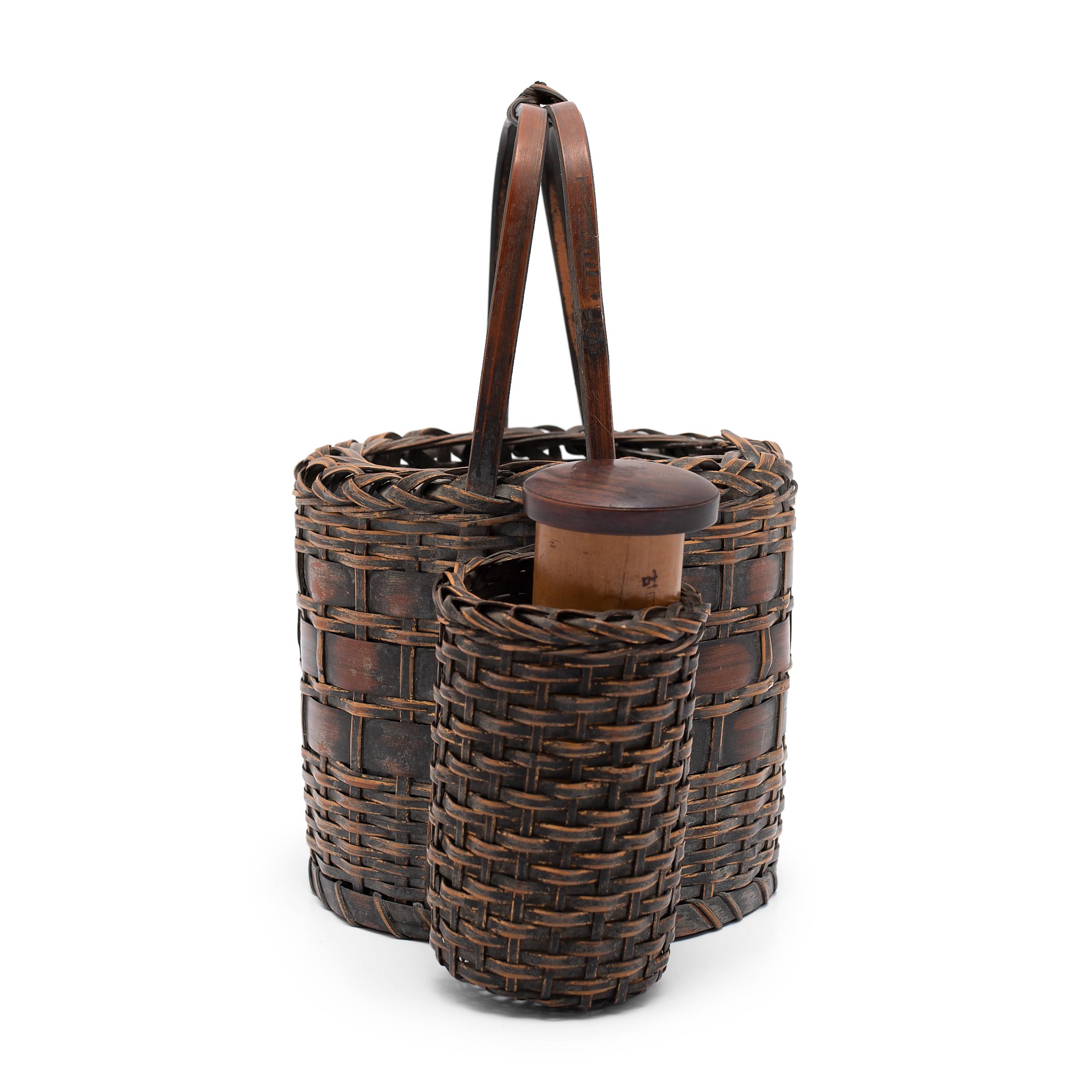 This woven basket is actually a Japanese tabako-bon, or 'tobacco tray,' used as a portable hibachi for lighting tobacco pipes. Believed to have evolved from the traditional accessories of Japanese incense ceremony, tabako-bons first came into use in
