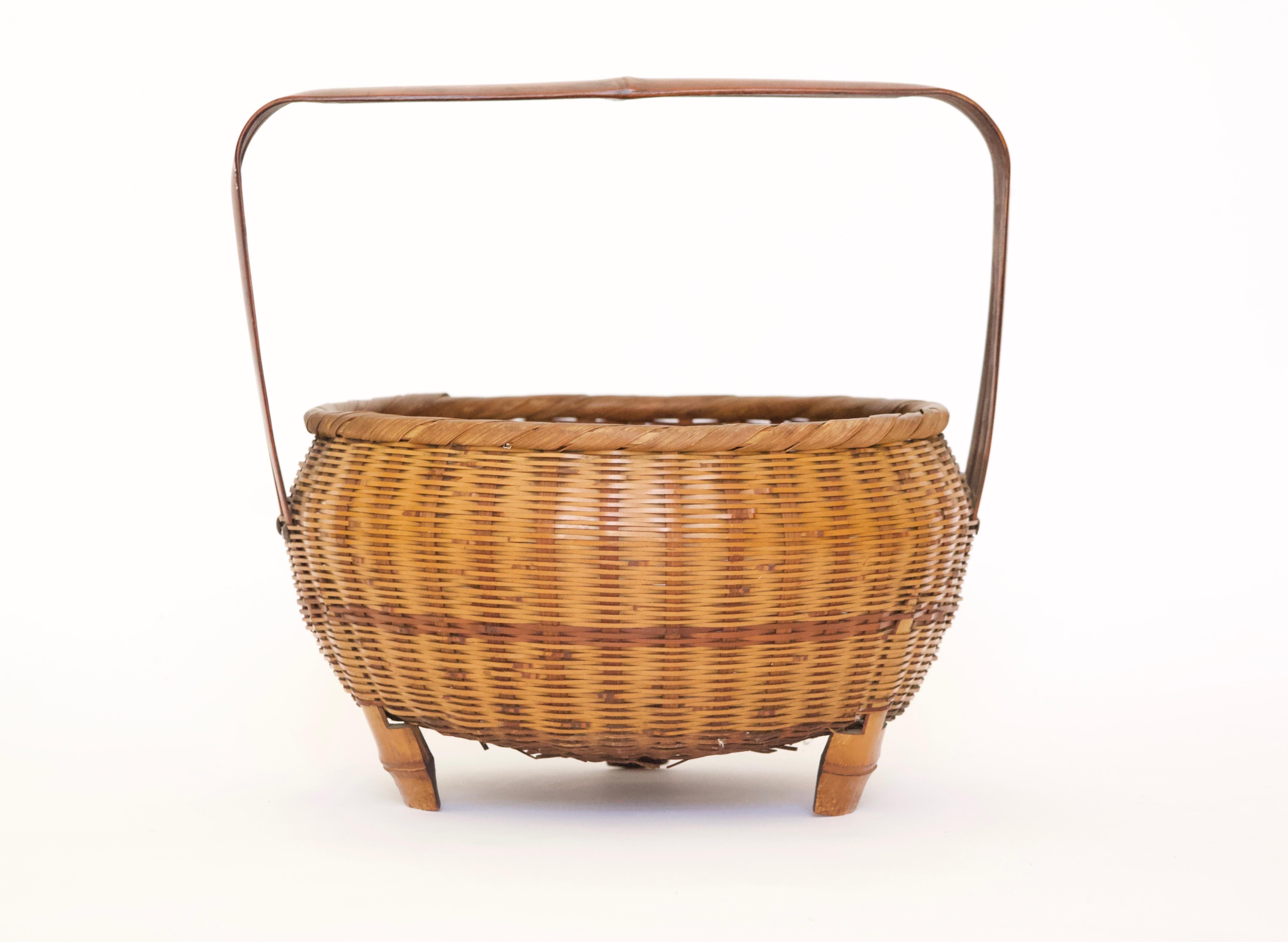Japanese Edo era style woven bamboo basket with handle.