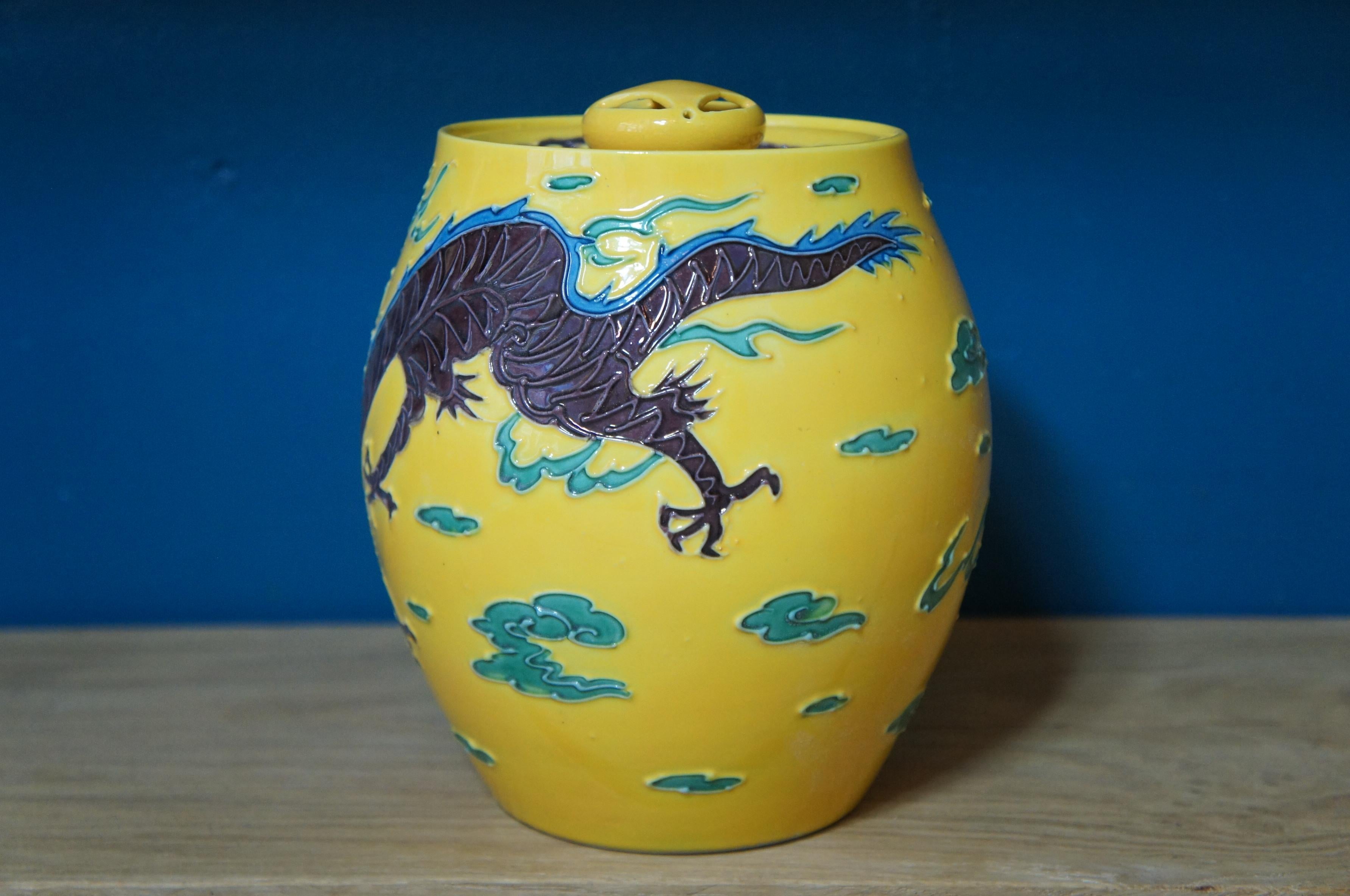 Beautiful Japanese yellow porcelain vase with lid.
With 3 dimensional image of a flying brown dragon among green clouds, from inspired Chinese style.
    