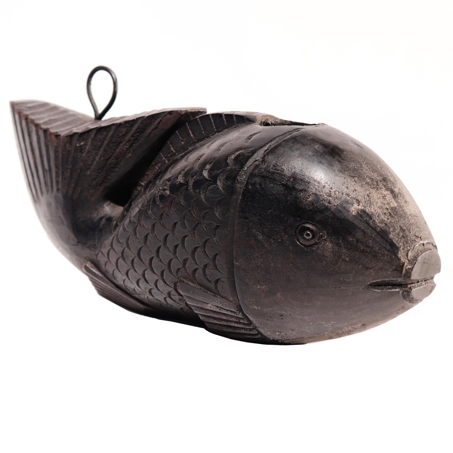 Japanese Yokogi, a fish shaped fulcrum for the pot hook assembly over the hearth, a naively carved Tai (Sea Bream) with large head pierced for the hooked pole and the large tail pointed upward with a metal loop for the cord attachment, light incised