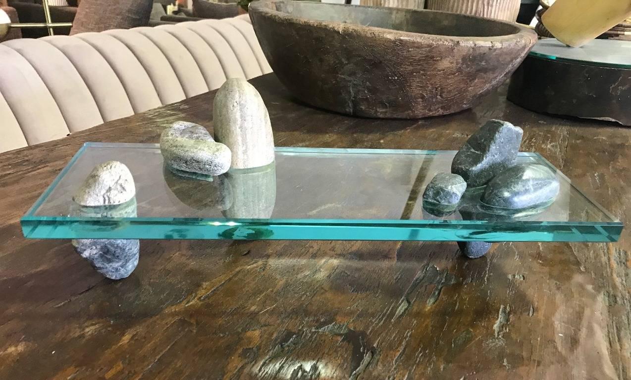 A rather unique and unusual piece. Certainly caught our eye when we first saw it. The rocks are displayed like a Japanese Zen Garden and are perfectly encased in a very thick, heavy piece of glass. Though not signed, clearly this was made by an