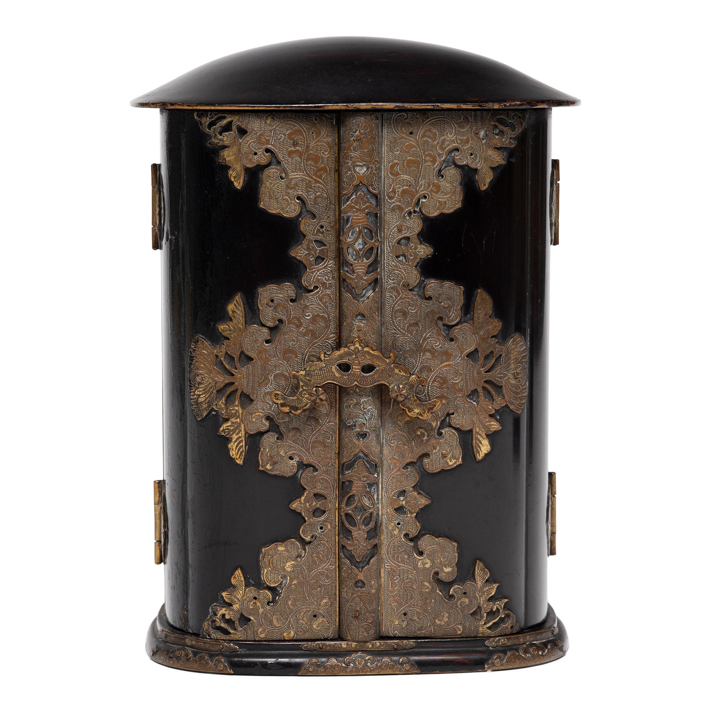 The simple exterior of even black lacquer that encases this 19th-century Japanese traveling shrine (zushi) belies the splendor within. The hinged doors open to reveal a lustrous gold interior, darkly contrasted by a mysterious grotto landscape.