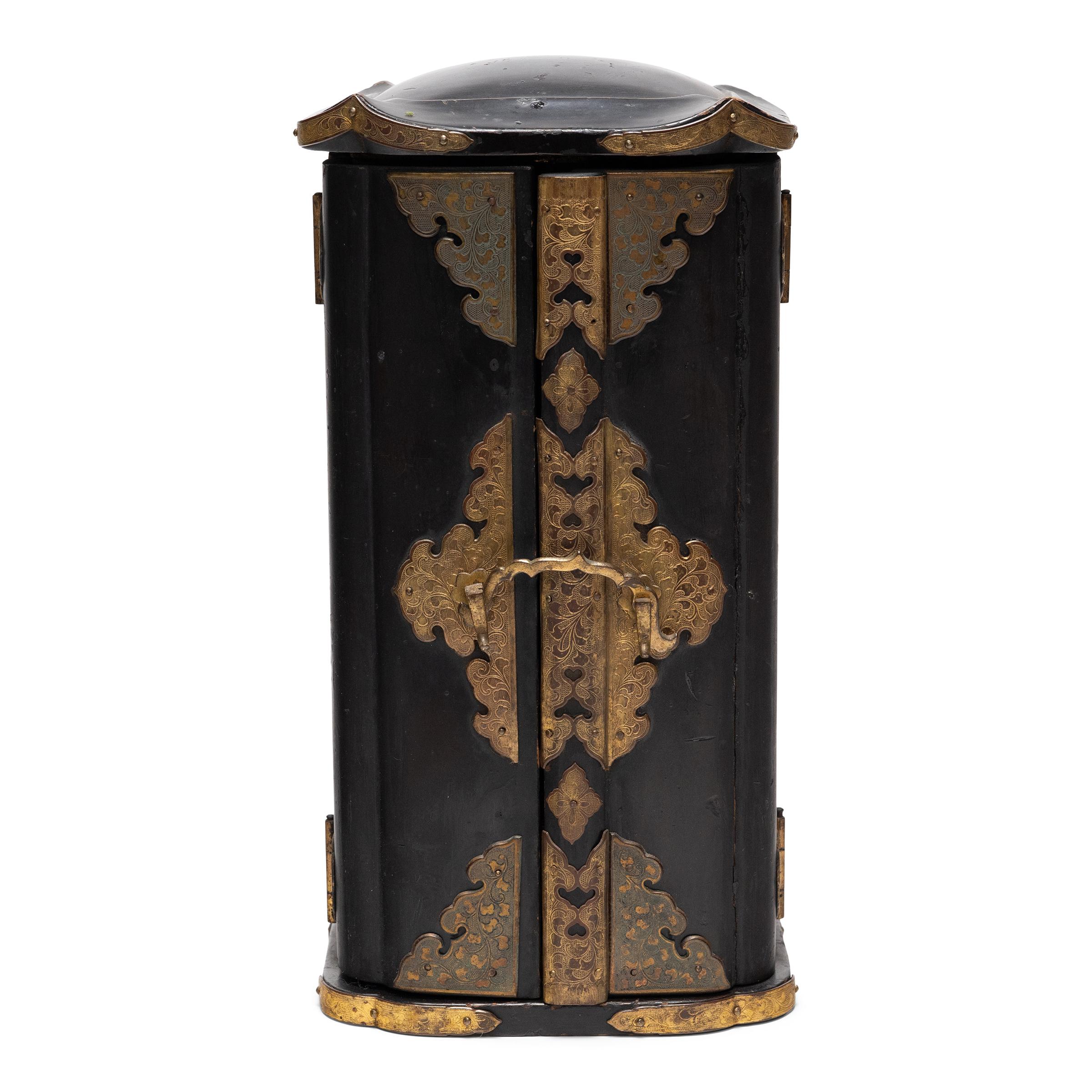 The simple exterior of even black lacquer that encases this early 19th-century Japanese traveling shrine (zushi) belies the splendor within. The hinged doors open to reveal a lustrous gold interior, beautifully hand-painted with lotus flowers and