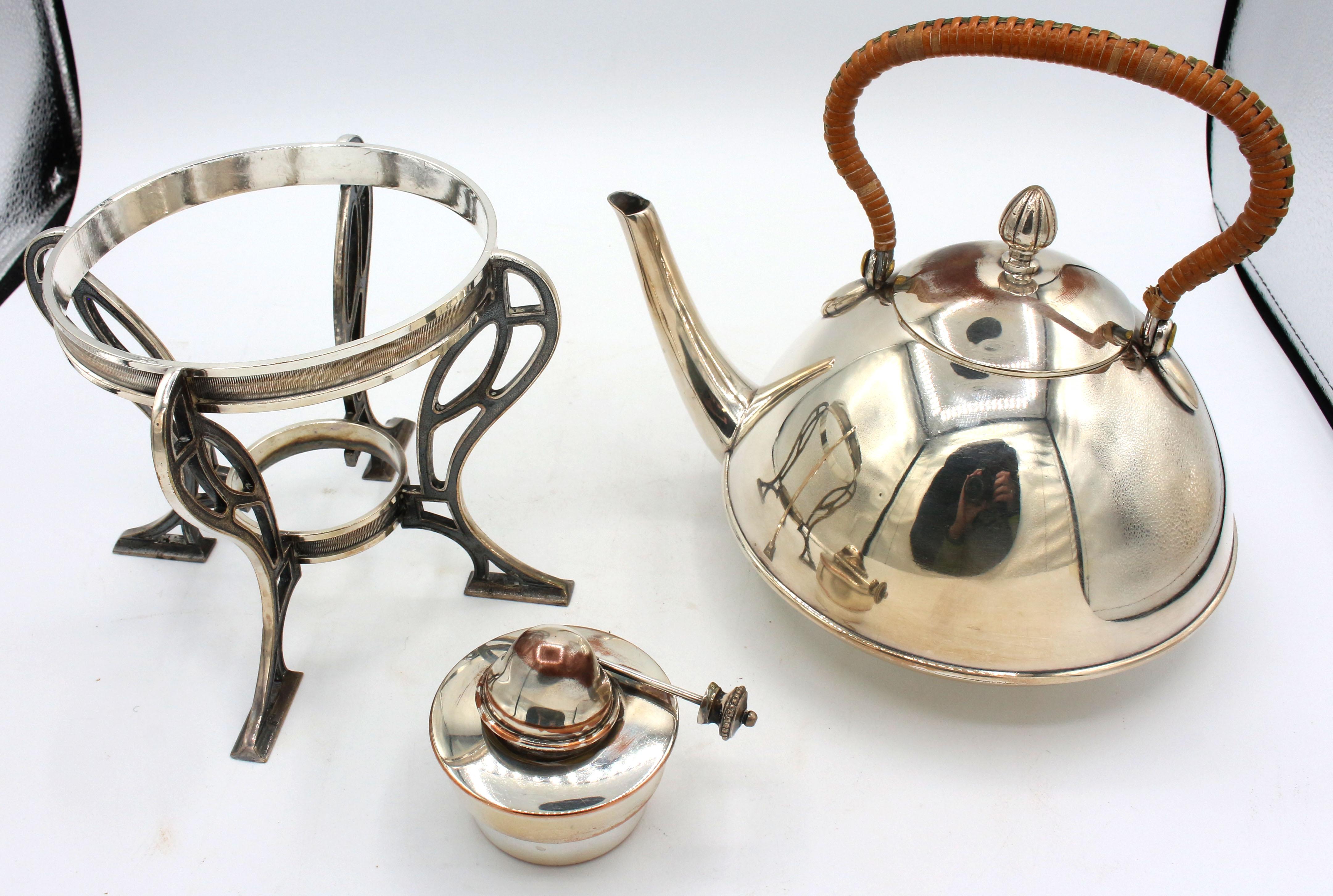 Japonisme spirit kettle on stand with burner, c.1900, probably Stockholm. Arts & Crafts substyle. Silver on copper kettle & burner, silver on brass or bronze stand. Marked: GAB & MS. Raffia wrapped handle. Some copper bleeding, especially on the
