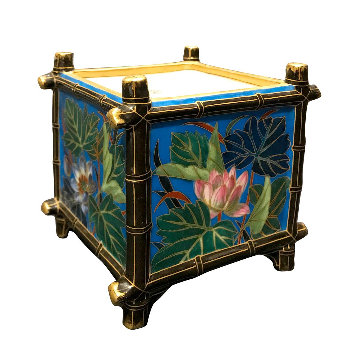 Exquisite square planter in the Japonisme style. The whole planter is structured on bamboo-style edges.
Each face is decorated with flowers and leaves on a vivid blue background/ Each side has a different pattern and all the designs are framed by a