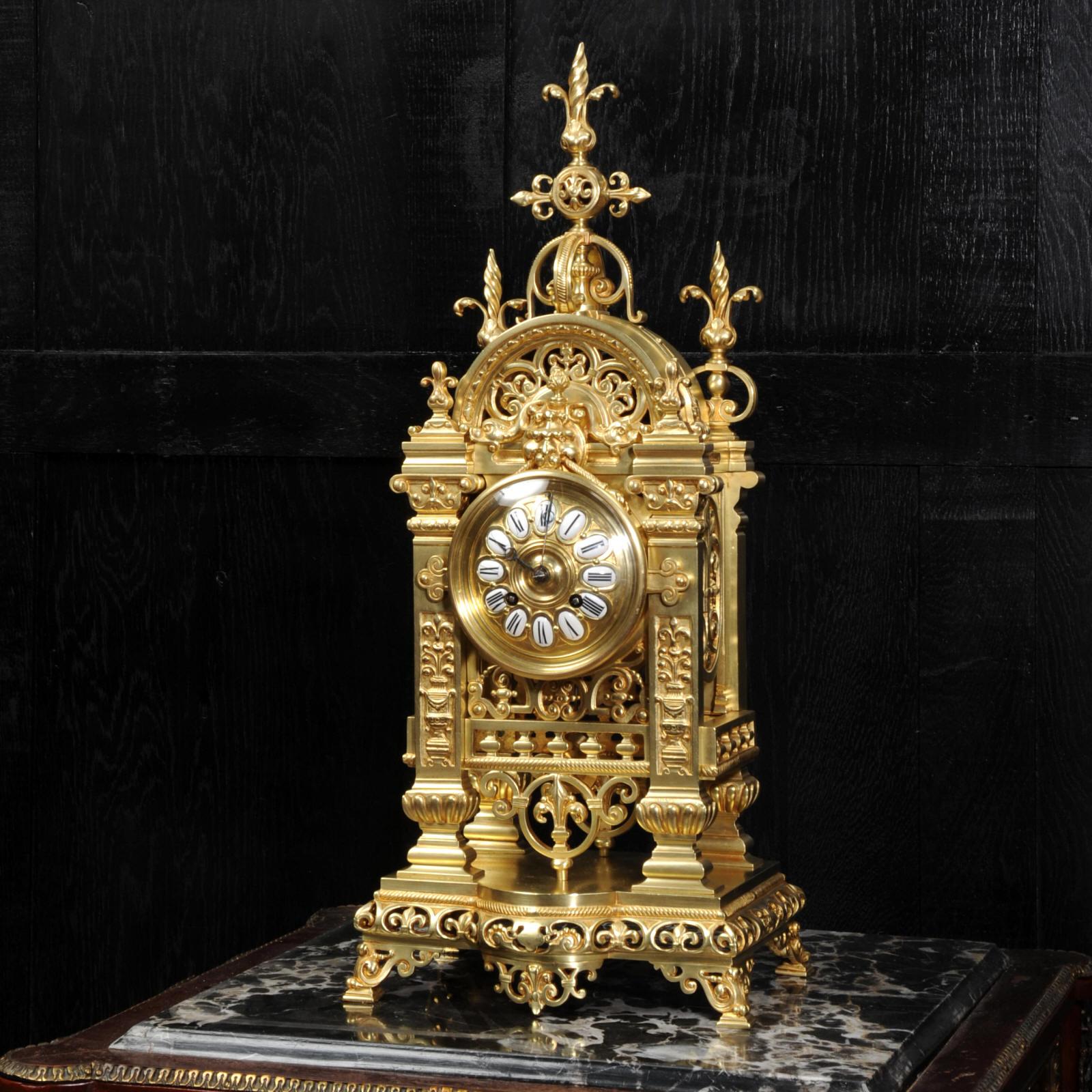 A superb antique French clock by Japy Frères, circa 1870. It is very well made in gilt bronze in the Gothic style. The case is architecturally formed of 4 gothic columns supporting fretted tracery panels allowing the pendulum to be seen gently