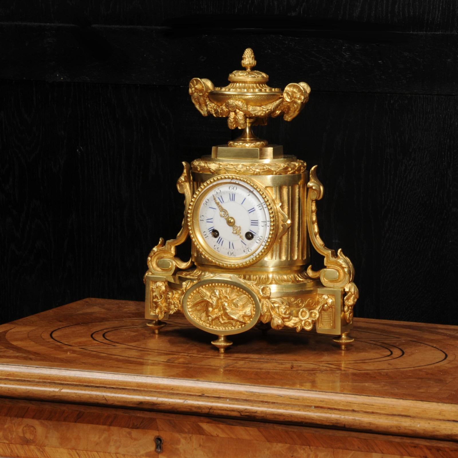 A superb Japy Frères antique French ormolu boudoir clock, circa 1860. It is classical in style with scrolls, acanthus panel with birds and a large urn with rams head handles to the top. The lid of the urn opens for storage of small items. The ormolu