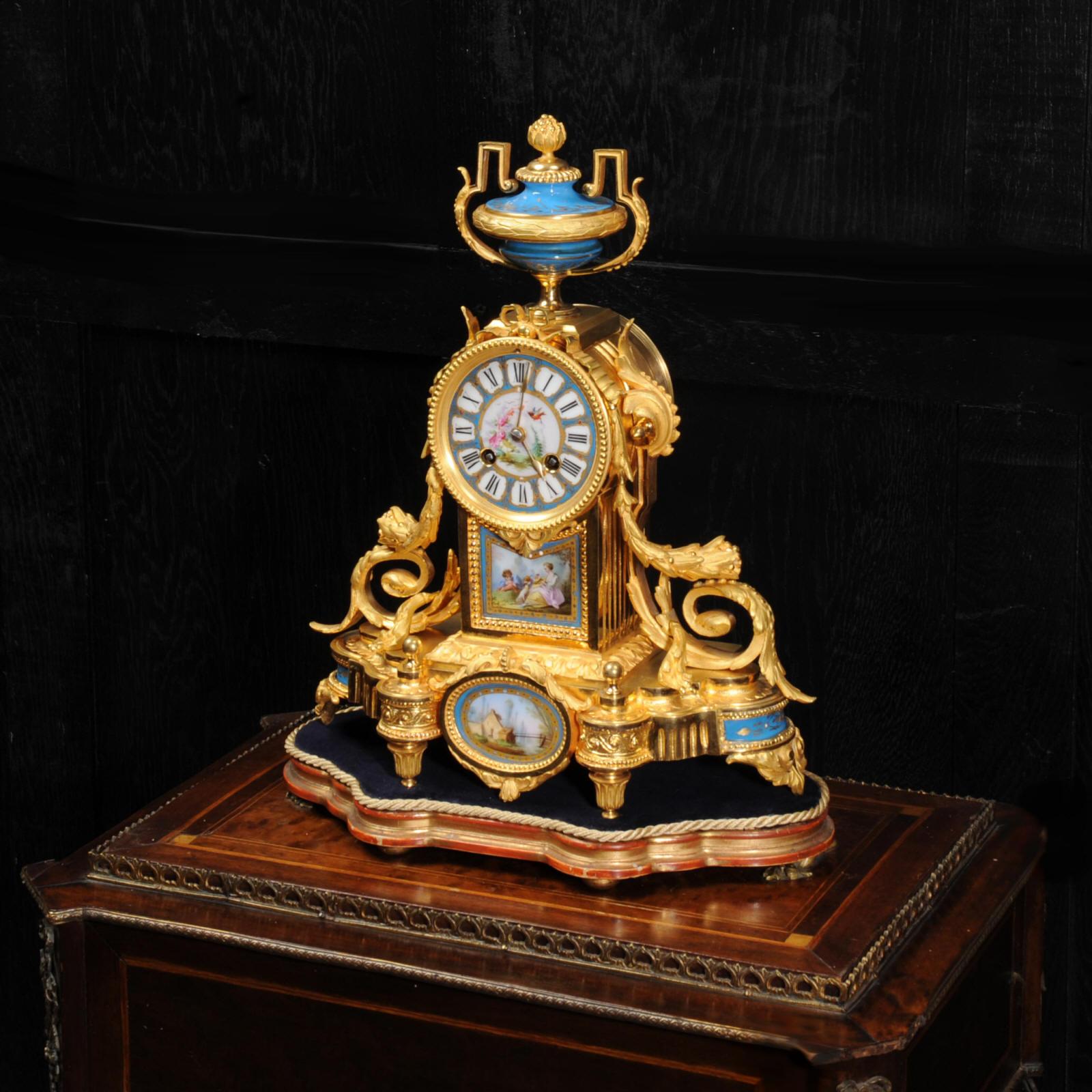 A stunning original antique French clock by Japy Freres. The crisp ormolu (finely gilded bronze), beautifully modelled and chased, is mounted with exquisite Sèvres style porcelain. Porcelain has a blue ground and is delicately painted with a