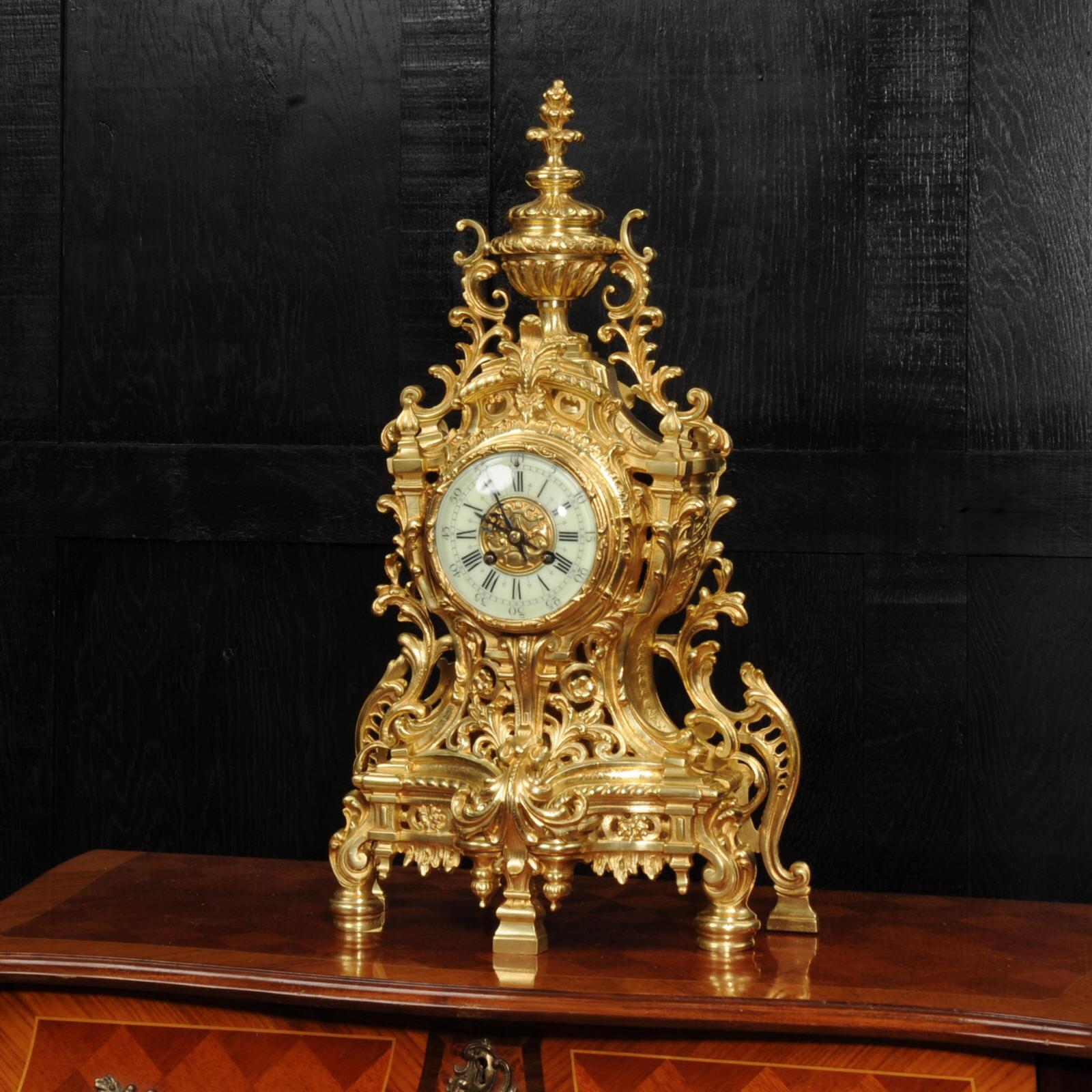 A stunning original antique French clock by Japy Frères. It is beautifully made in gilded bronze in the Louis XV style. Waisted case with a fretted front to allow a glimpse of the pendulum gently swinging inside. Profusely decorated with acanthus, C
