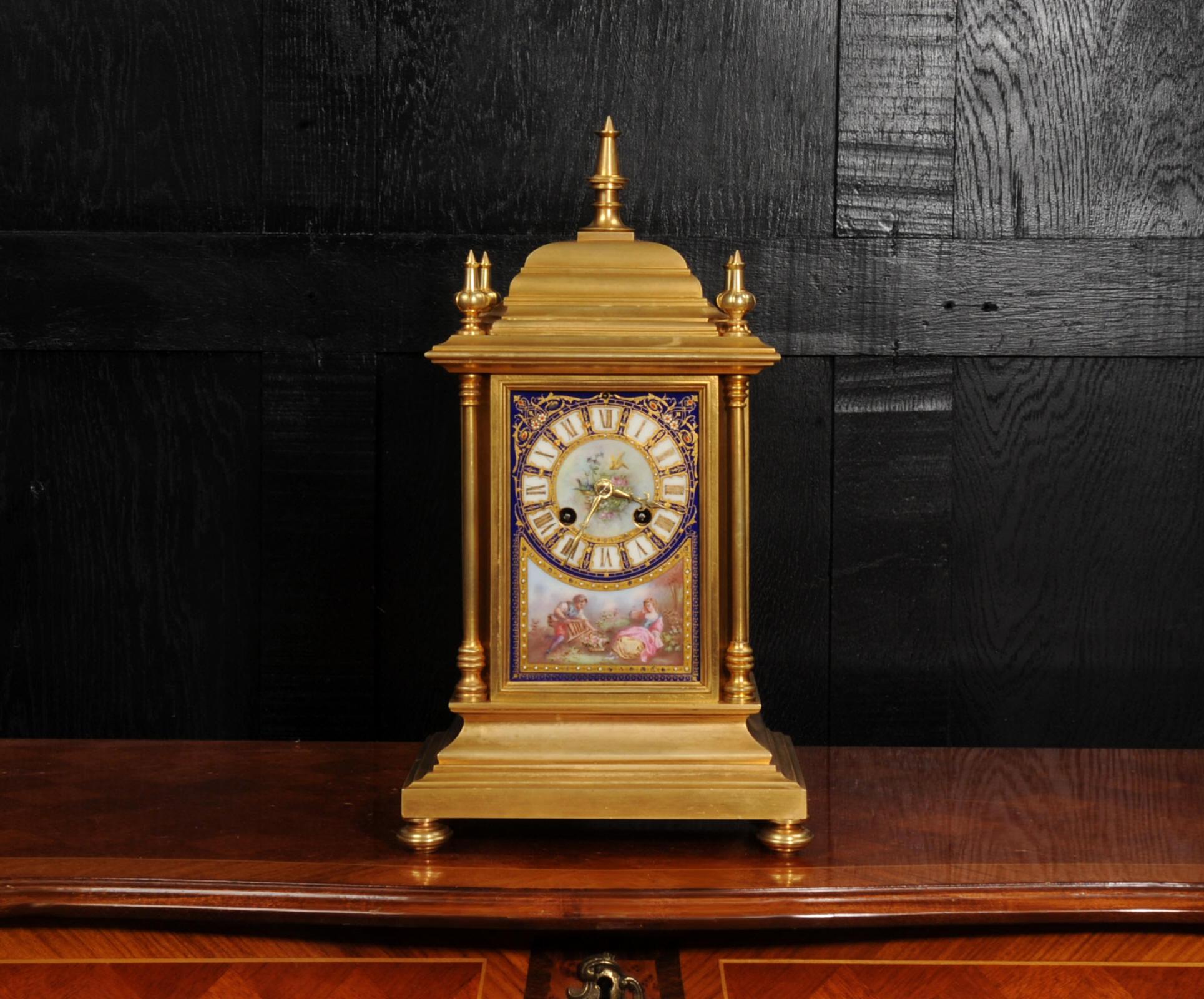 A magnificent ormolu (finely gilded bronze) and Sèvres style porcelain clock by renown maker Japy Frères. It is of a beautifully chic design, four turned corner columns with a cushion shaped top with 5 finials. The front and sides are mounted with