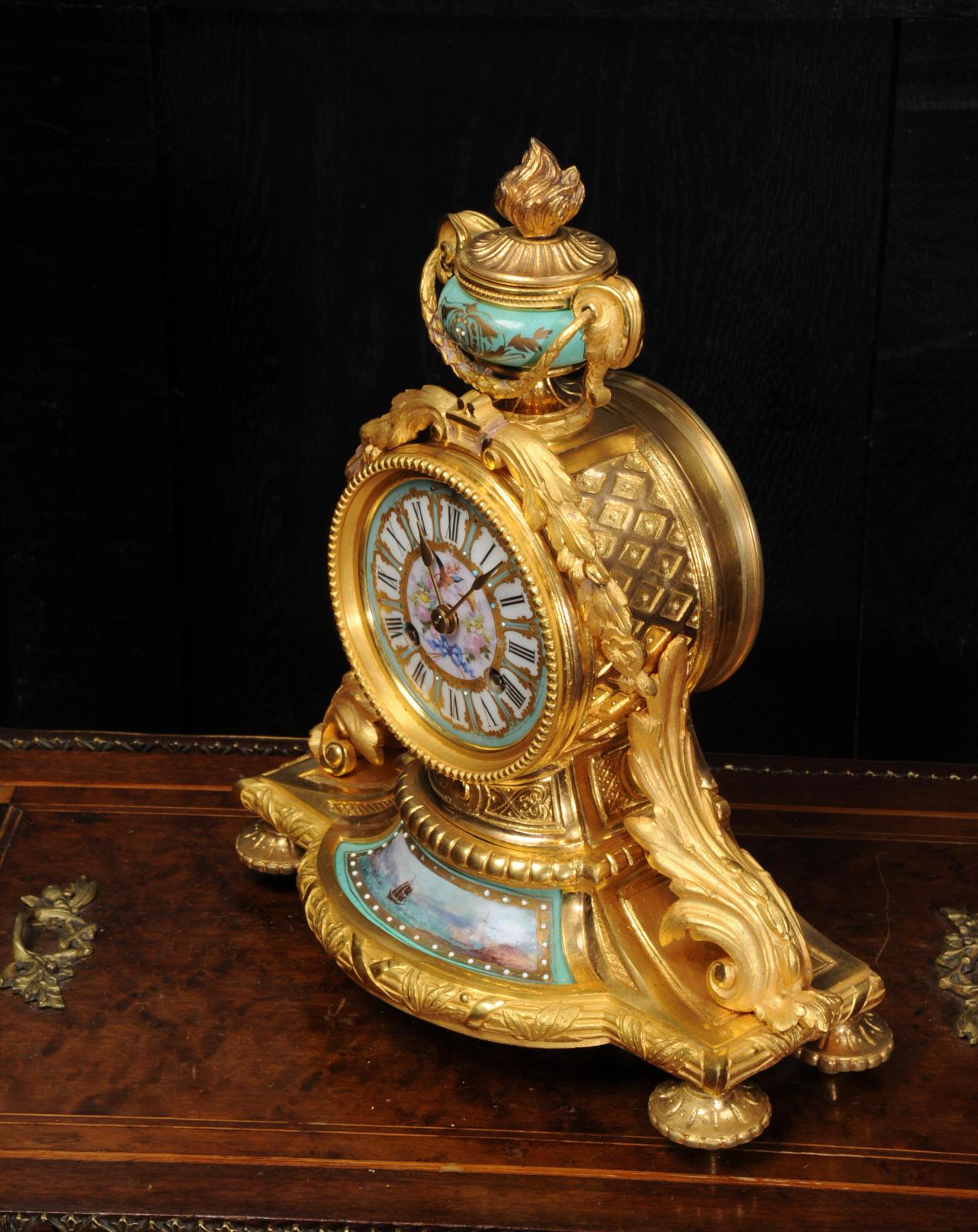 A lovely original antique French clock by Japy Frères, circa 1880. It is finely modelled in ormolu (finely gilded bronze) mounted with exquisite Sèvres style porcelain with an elegant green ground. The lower panel is a beautifully painted seascape