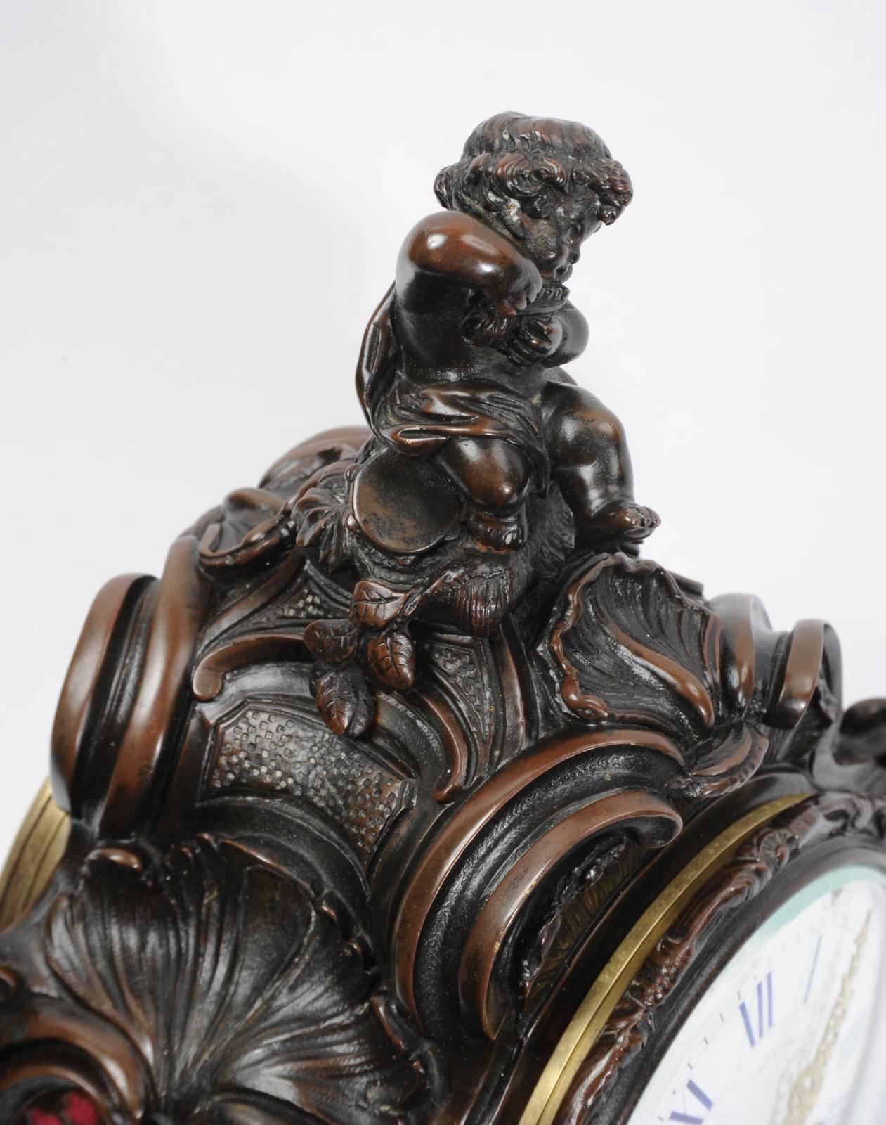 A superb original antique French Rococo clock by the famous maker Japy Freres, circa 1890. Beautifully detailed bronze case with C scrolls, acanthus and shell motifs. A charming cherub is seated to the top plays pipes. Fretted sound panels backed