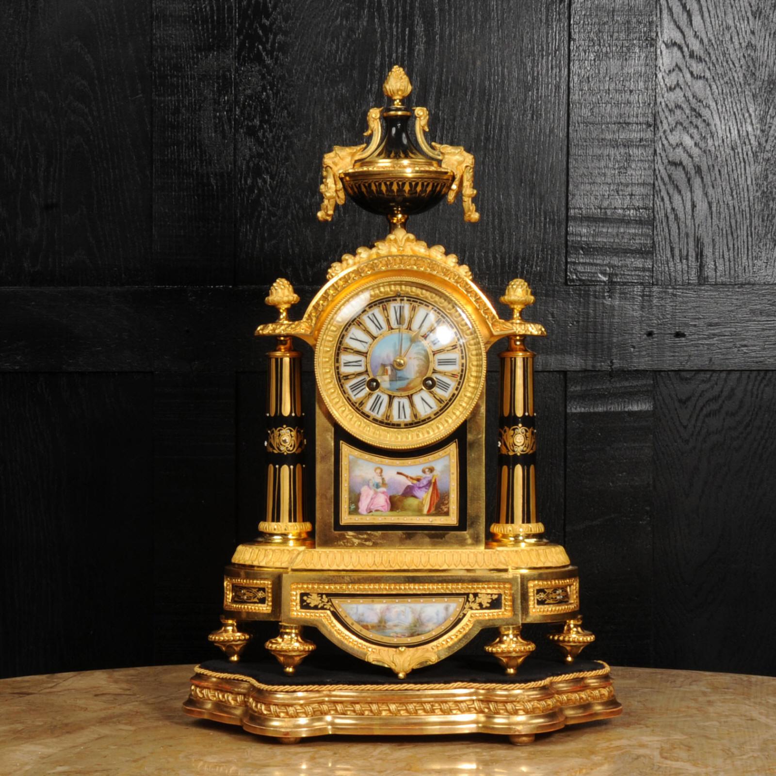 A beautiful original antique French clock by the famous maker Japy Frères and retailed by Henry Marc of Paris. Superbly made in ormolu and mounted with exquisite Sèvres style porcelain with delicately painted scenes on a black ground. The panel