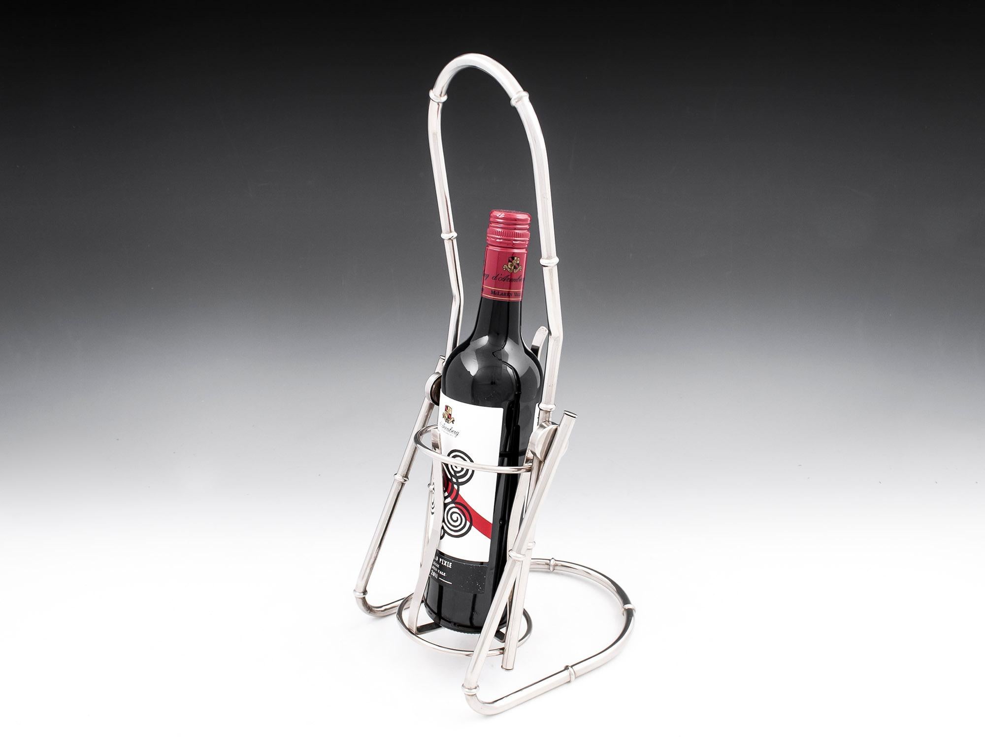Jacques Adnet silver plated tilting wine cradle / holder with a realistic bamboo design. The cradle holds the wine bottle very securely without fear of the bottle coming loose when pouring in to a glass. 

Great stylish piece for the dinner party