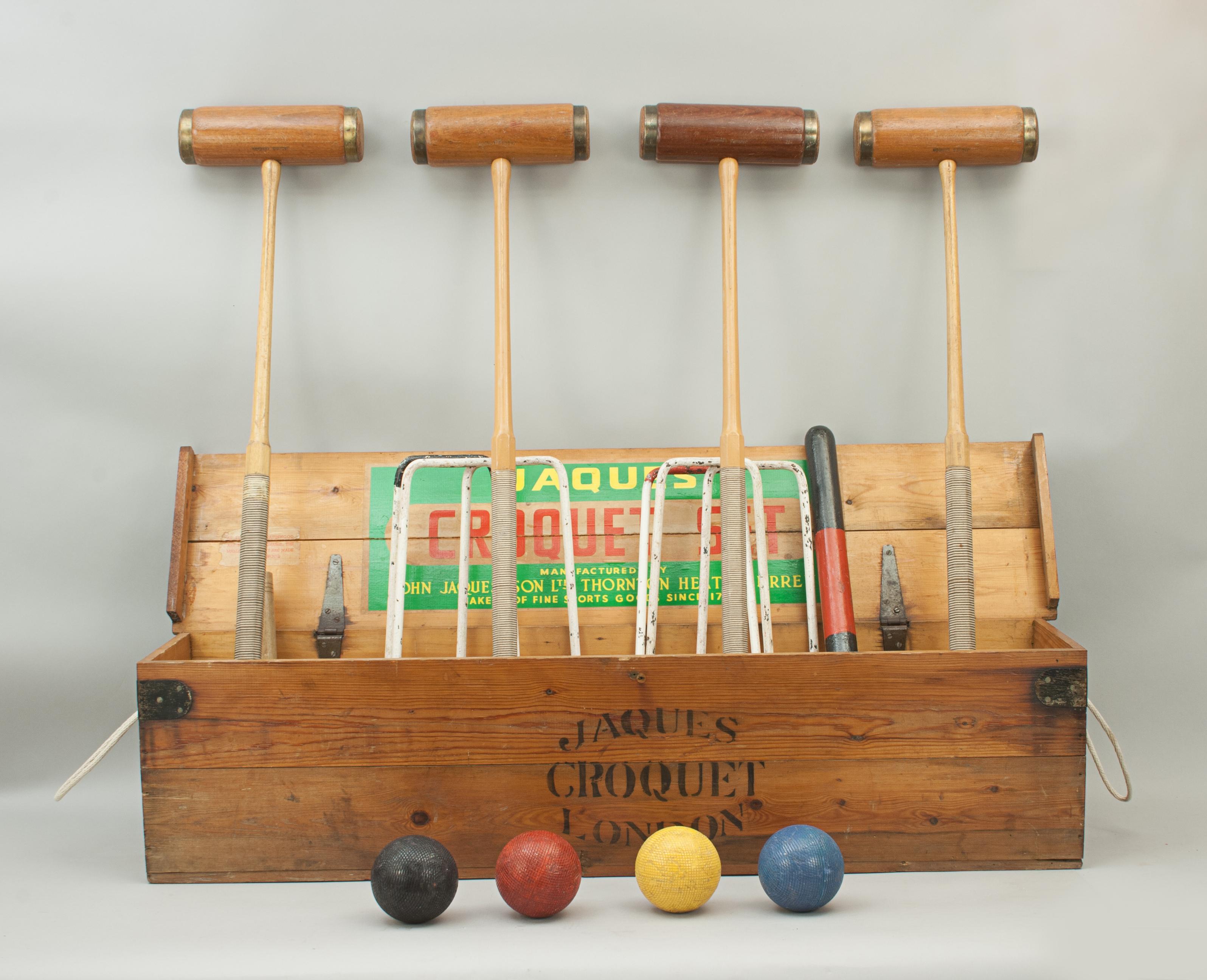 Vintage John Jaques croquet set.
A good quality Jaques croquet set in original pine box with four brass bound rockwood mallets with guide lines on the tops of the heads and octagonal handles with cord grips, each stamped Jaques London. To complete