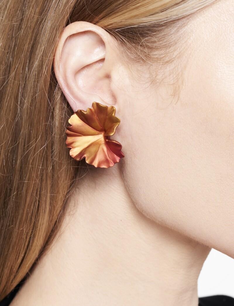 These JAR ear clips feature gilt aluminum in a fall foliage design one in red, orange and golden finish, the other in olive, red and orange finish.  1⅜ inch length. Signed JAR, Paris, numbered 11. French assay and workshop marks. 18K rose gold and