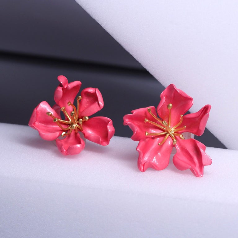 Earrings by Joel Arthur Rosenthal aka JAR Paris

Designed as a pair of almond blossoms, composed of sculpted silver petals applied with pink enamel, centering gold pistils, signed JAR Paris and numbered, with French assay and workshop marks. With
