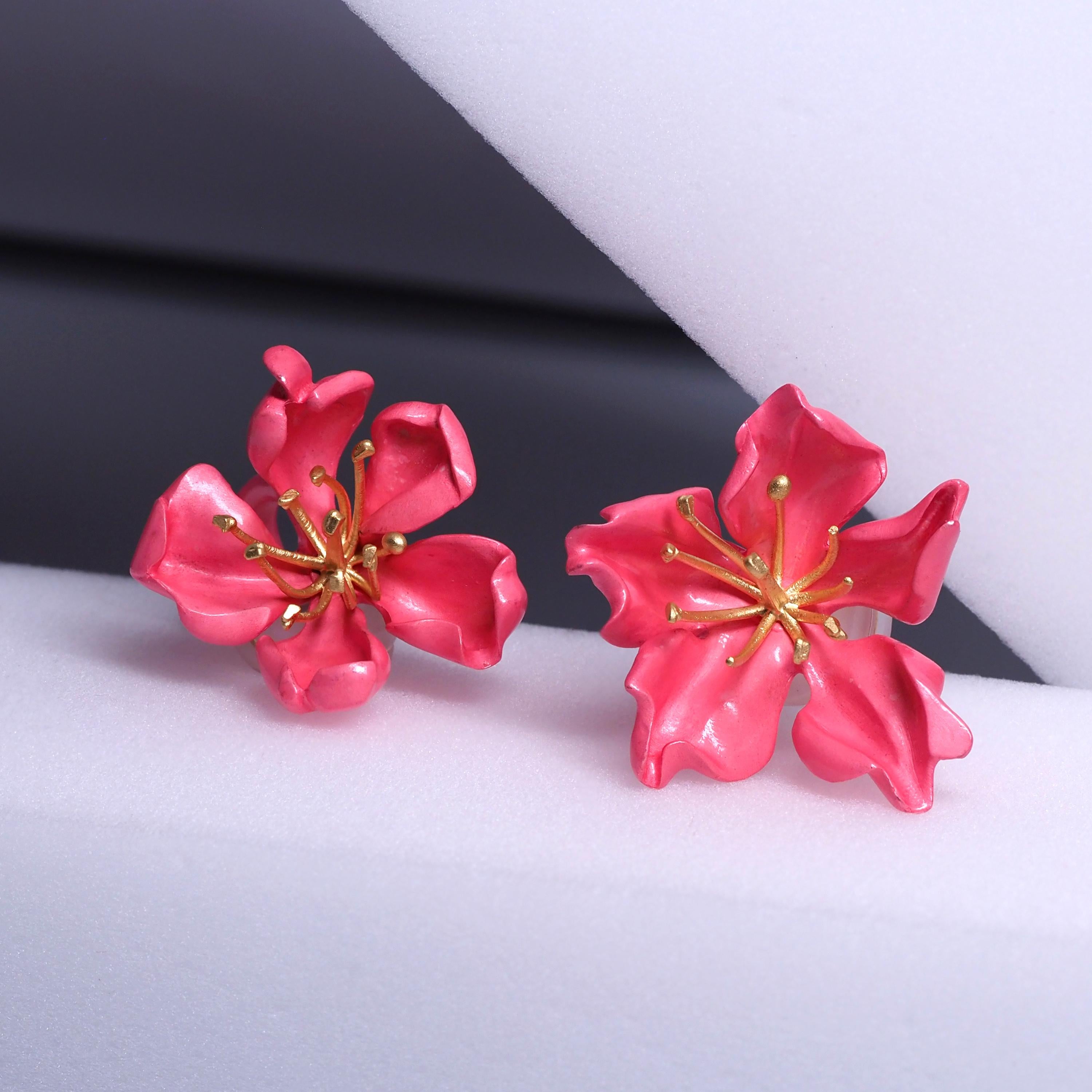 Earrings by Joel Arthur Rosenthal

Designed as a pair of almond blossoms, composed of sculpted silver petals applied with pink enamel, centering gold pistils, signed JAR Paris and numbered, with French assay and workshop marks. With signed pink