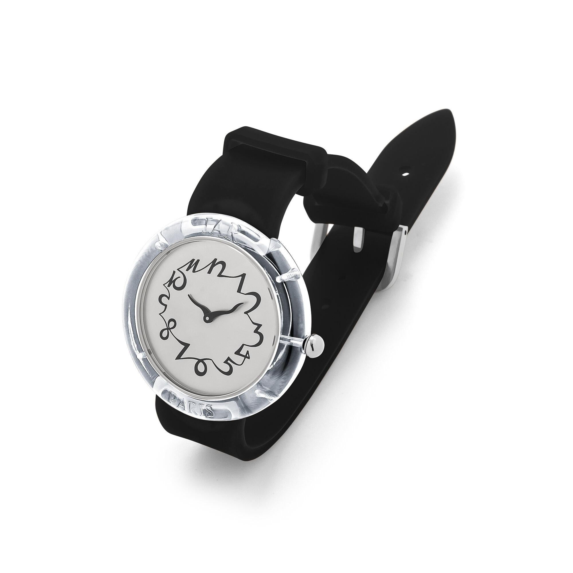 This JAR designed and collectible vintage watch from the Metropolitan Museum of Art collection is wearable fine art.  With a chic black silicone watch strap, a silver face, and a clear perspex bezel, this watch is sleek and masterfully designed.