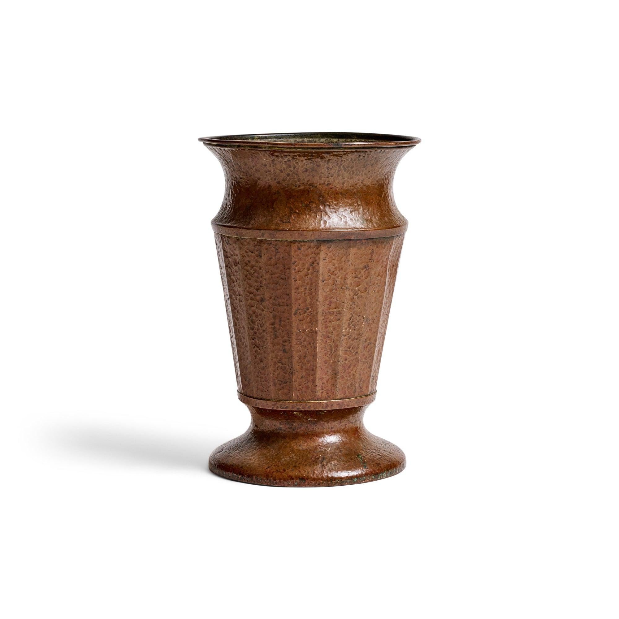 A excellent hammered copper classical-shaped jardiniere of double walled construction with a lead filled base.