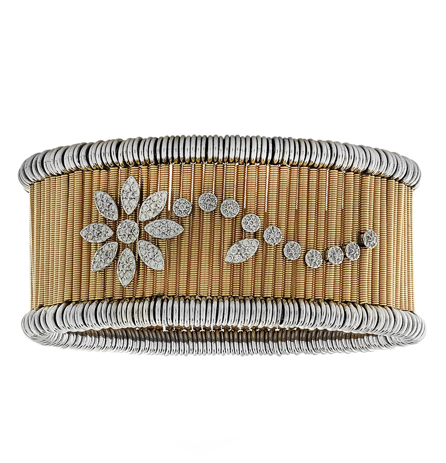 Jarretiere expandable bangle bracelet expertly crafted in Italy in 18 karat yellow gold and white gold, featuring 158 round brilliant cut diamonds weighing approximately .79 carats total. Yellow gold coils trimmed with white gold coils, are adorned