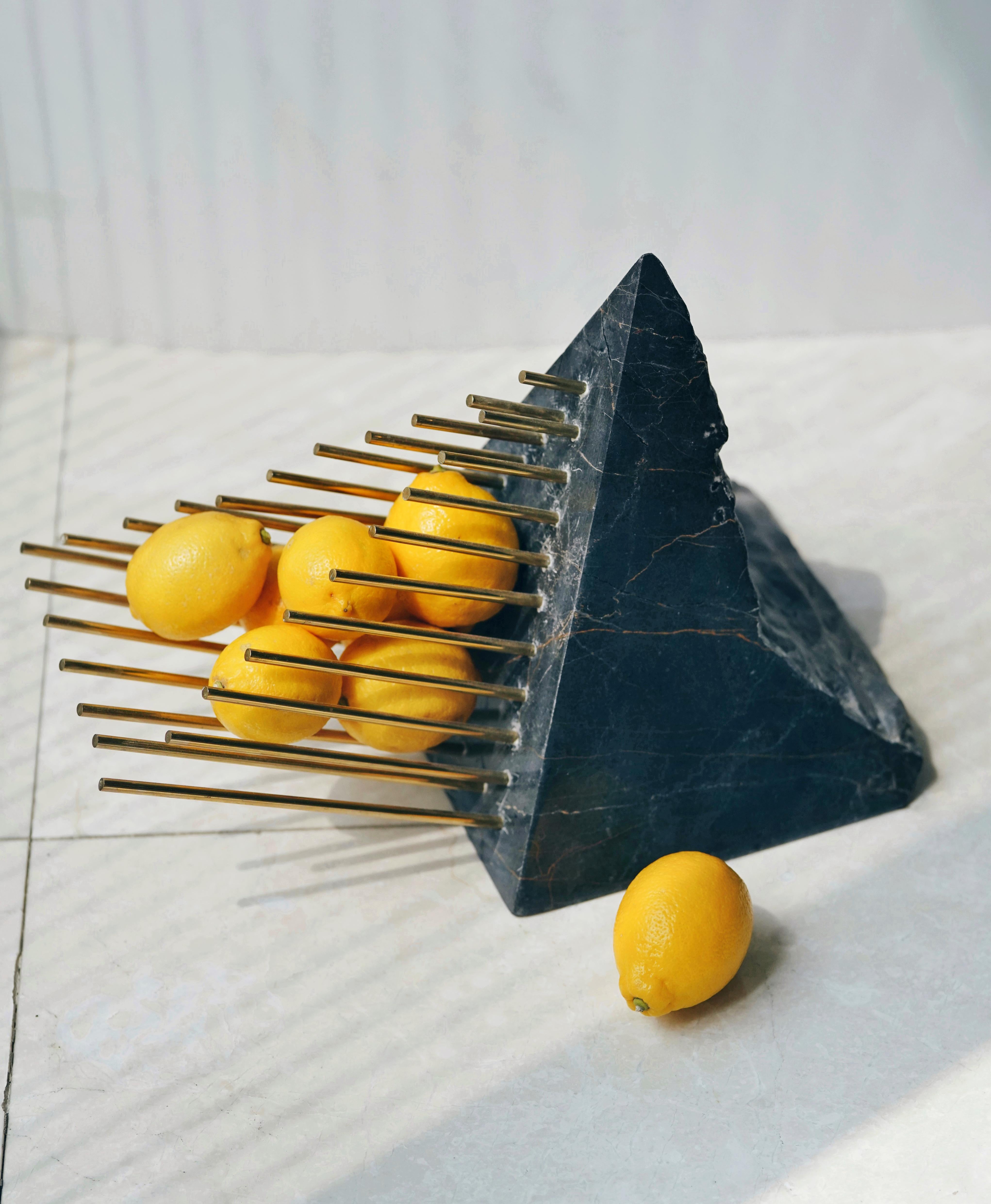 Jari fruit bowl by Elham Nejati
Dimensions: Ø 36 x H 28 cm.
Materials: Black marble, white marble, stainless steel, brass. 

Elham Nejati:
