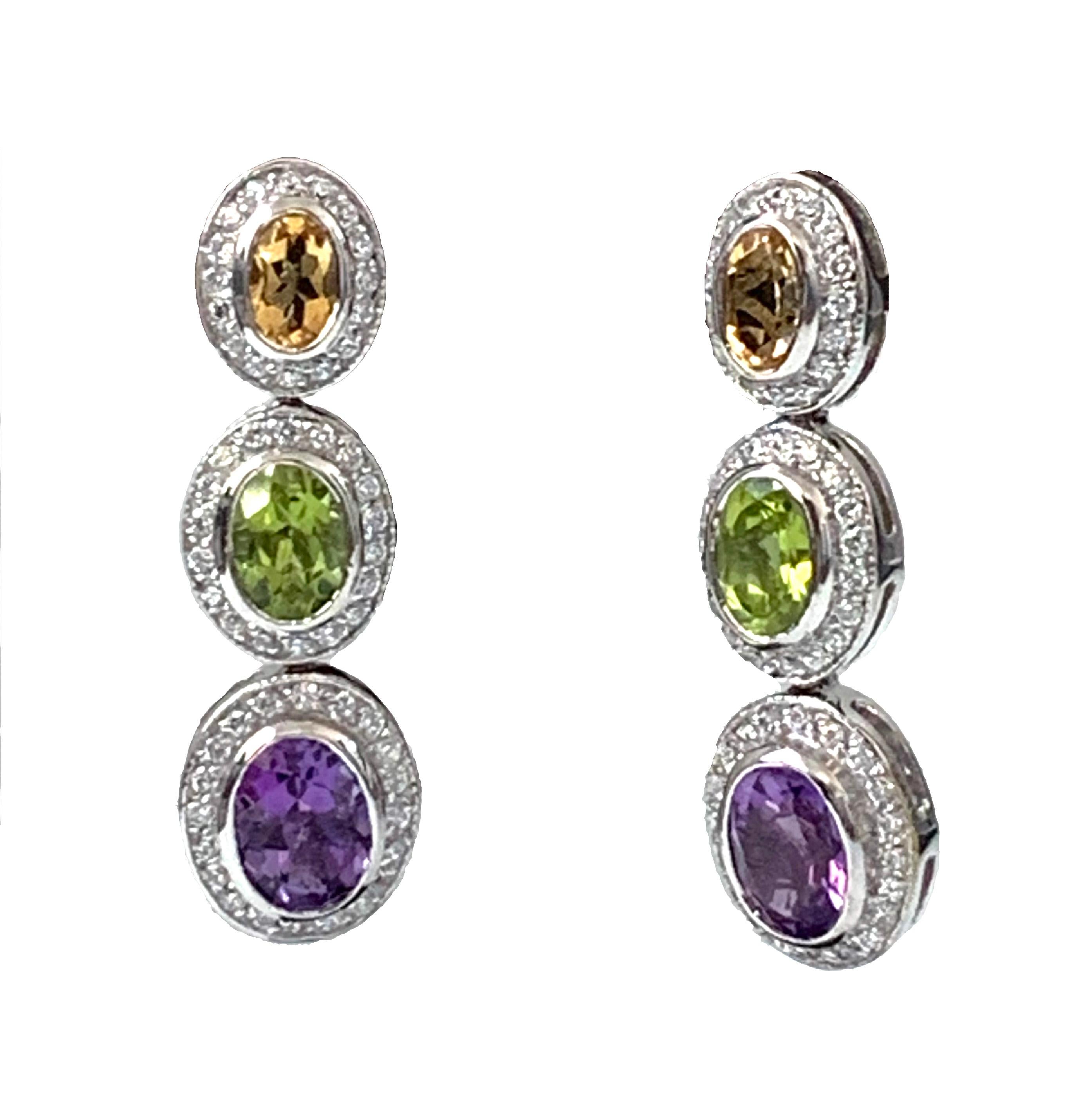Beautiful multicolor oval gemstones (Citrine, Peridot, and Amethyst) adorned with round Cubic Zirconia drop earrings. Platinum rhodium finished. Straight post. Marked: Jarin

1.5