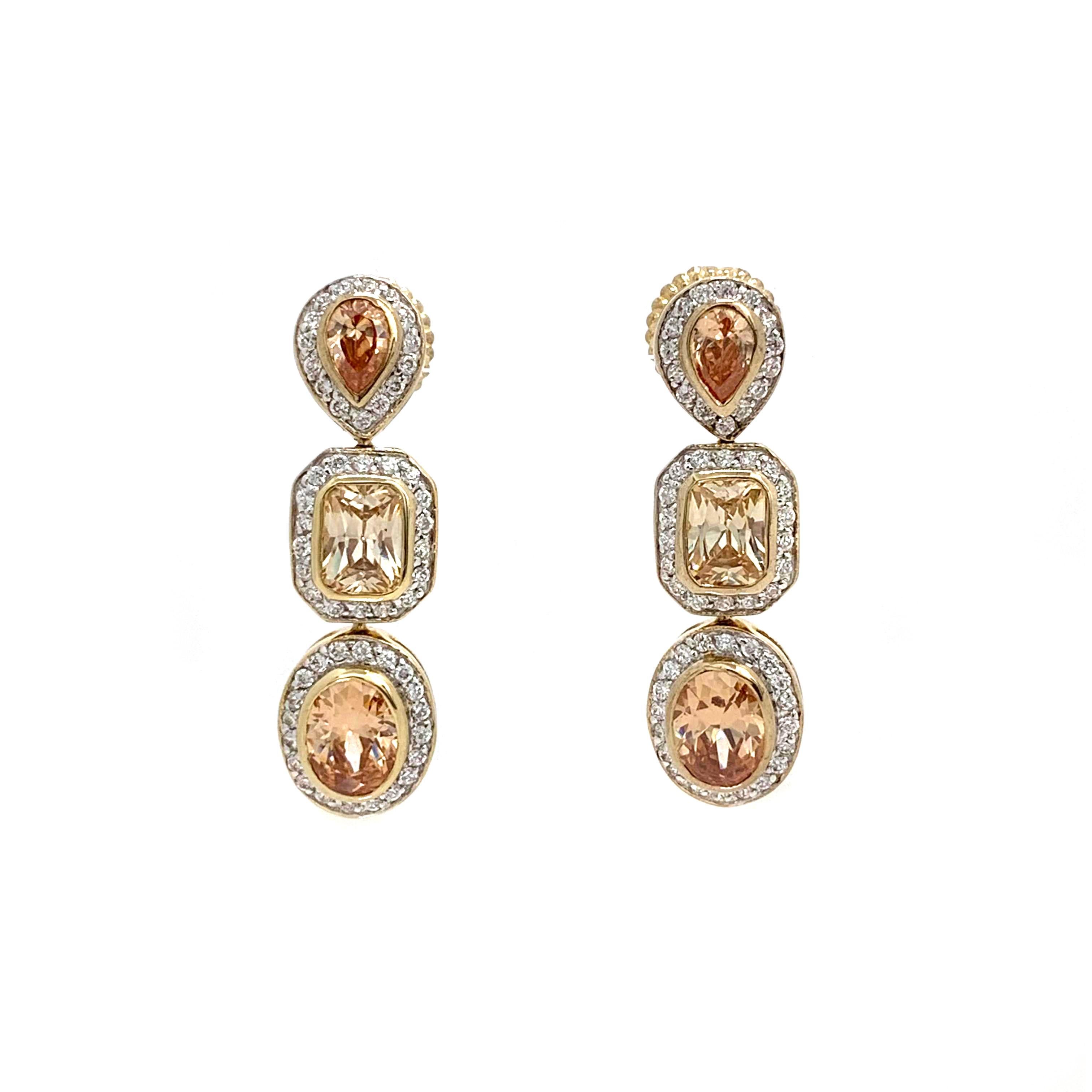 Beautiful triple faux champagne diamond adorned with round Cubic Zirconia drop earrings. 18k gold finished. Straight post with large friction back. Marked: Jarin

1-3/8
