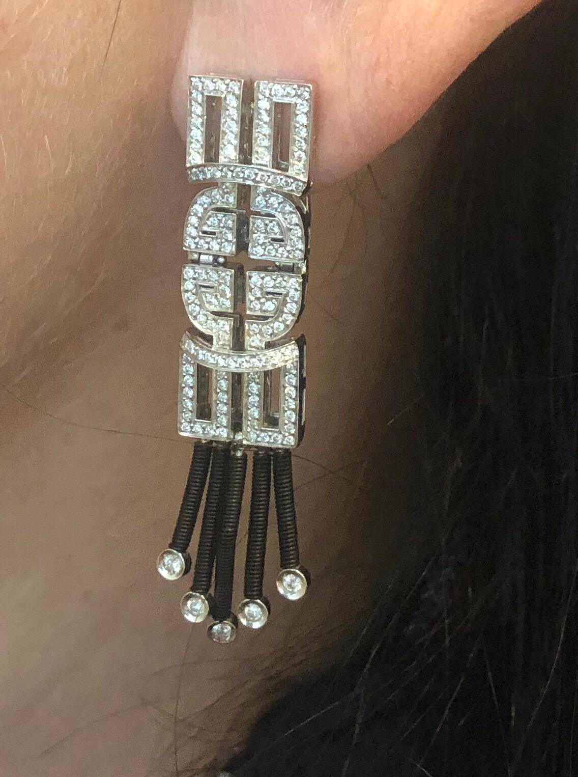 Jarretiere 18K black gold earrings, flexible geometric design with full cut round diamonds weighing .98cts
Retail $8580