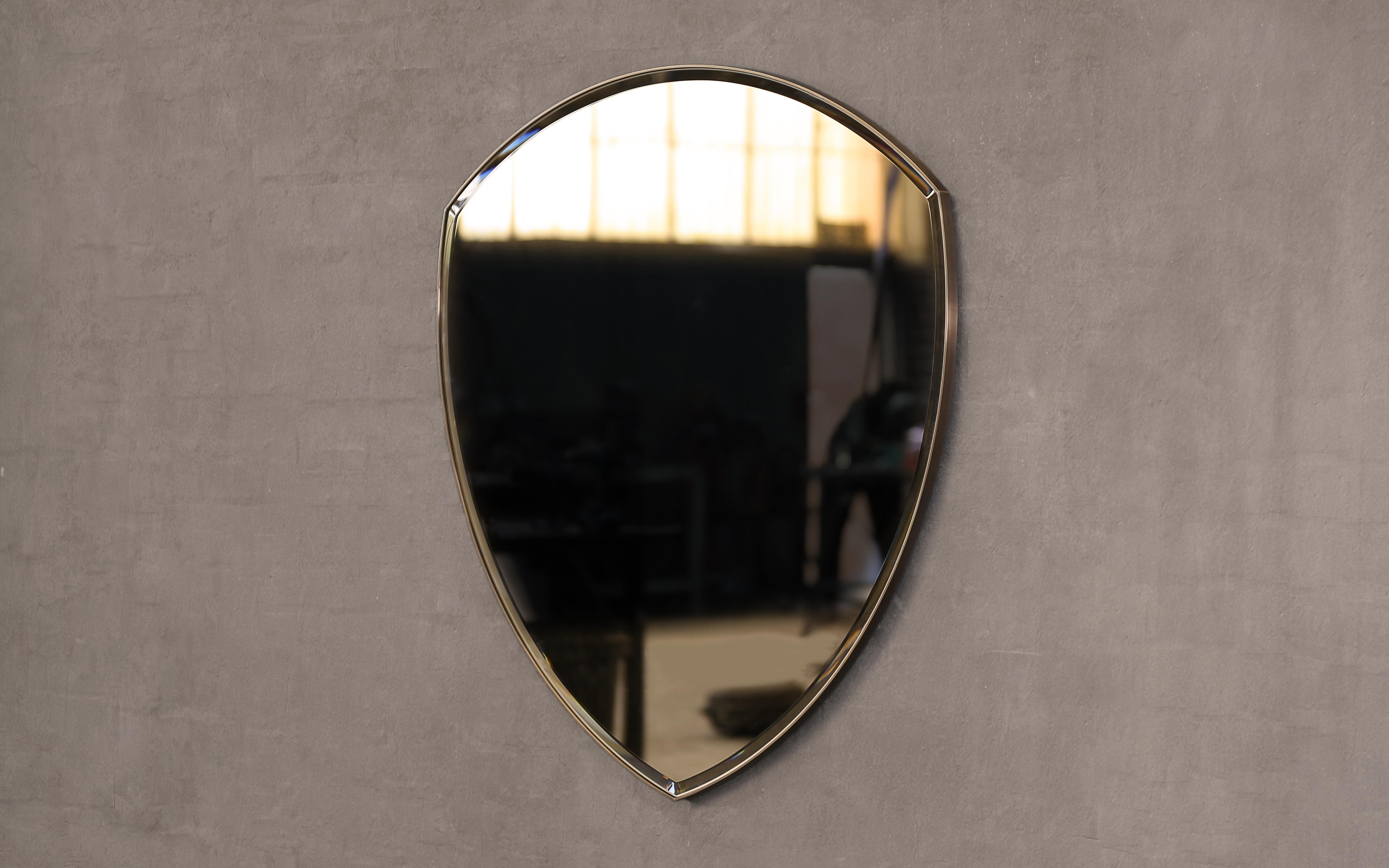 A wall mirror in polished brass and bevelled, bronze tinted glass. Hand crafted in the North to order. 

Supplied with two screw fixing points to rear face. Larger mirrors supplied with batten fixing.

Measures: 114cm (W) x 116.5cm (H) x 2cm