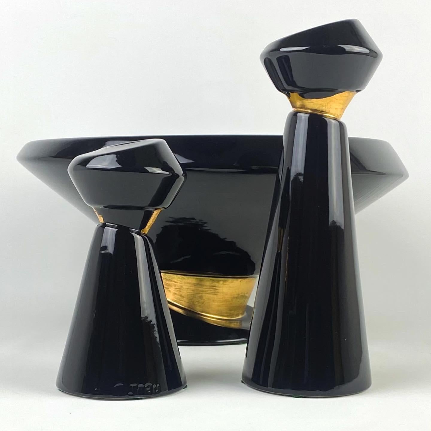 Vintage 80s Jaru Asymmetrical ceramic bowl and candle holder set. Jet black ceramic glazed with gold leaf accents. Made in California by Jaru Art Products
Rare set of 3 pieces.

Tall candle holder: 3.75” D x 3.75” W x 10.5” H
Short candle holder: