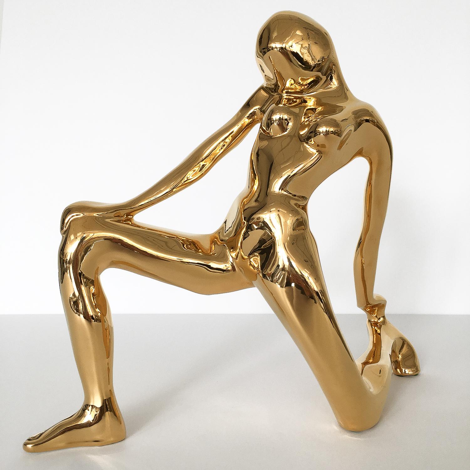 Modernist gold-plated ceramic sculpture of a stylized kneeling woman by Jaru of California, circa 1980. Signed 