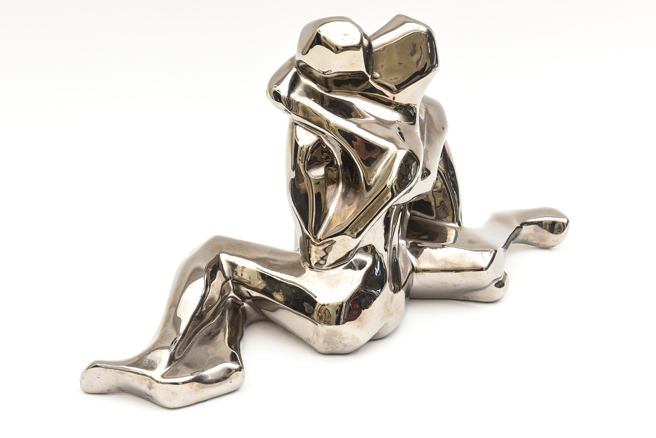 This wonderful signed vintage Jaru sculpture is platinum plated over ceramic. It is from the 70's and the most desirable and coveted one made. it is the lovers embrace. The art deco inspiration meets cubism meets modern of this figural sculpture.