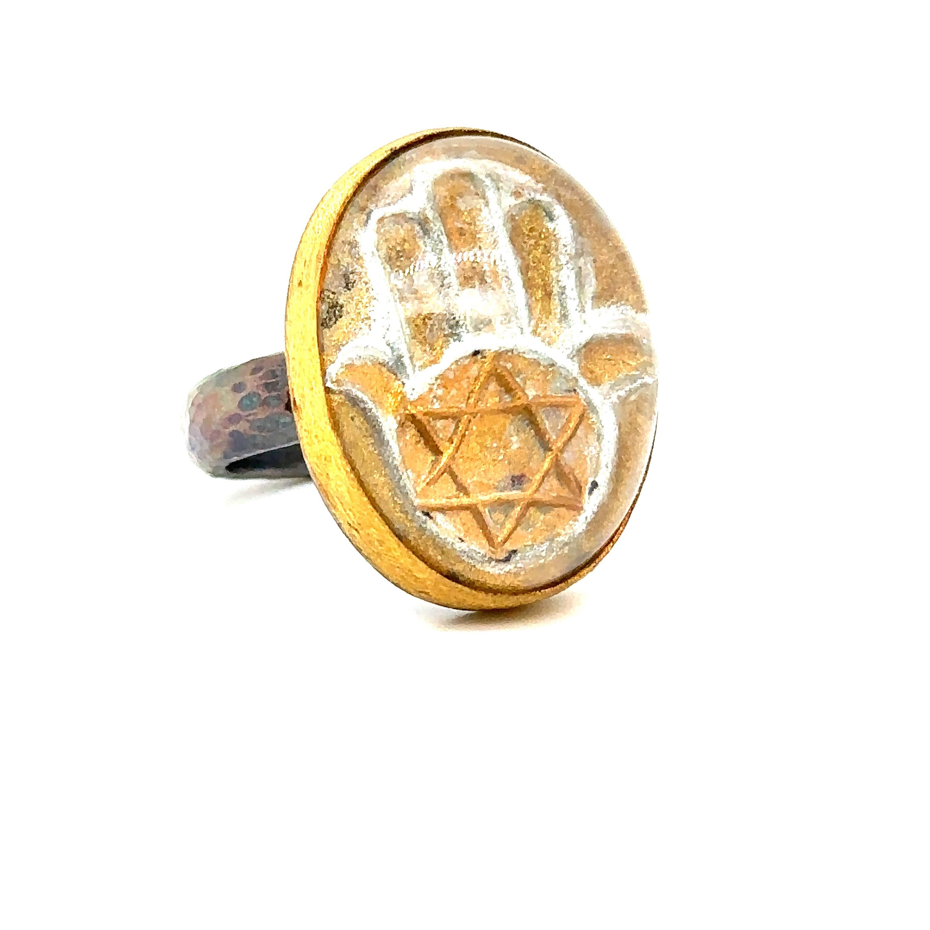 24K GOLD/STERLING SILVER HAMSA RING with 30.00CT CARVED QUARTZ 
Metal: 24K GOLD/SS
Stone Info: 30.00CT CARVED QUARTZ
Total Stone Weight: 30.0 cwt.
Item Weight:  16.80 gm
Ring Size: 8 (Re-sizable)
Measurements: 28.80mm x 20.75mm
