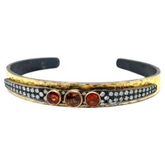 JAS-20-2054 - PULSERA DE ANILLO FLEXIBLE 24K/SS con DIAMANTES Y ZAFIRAS NARANJAS
