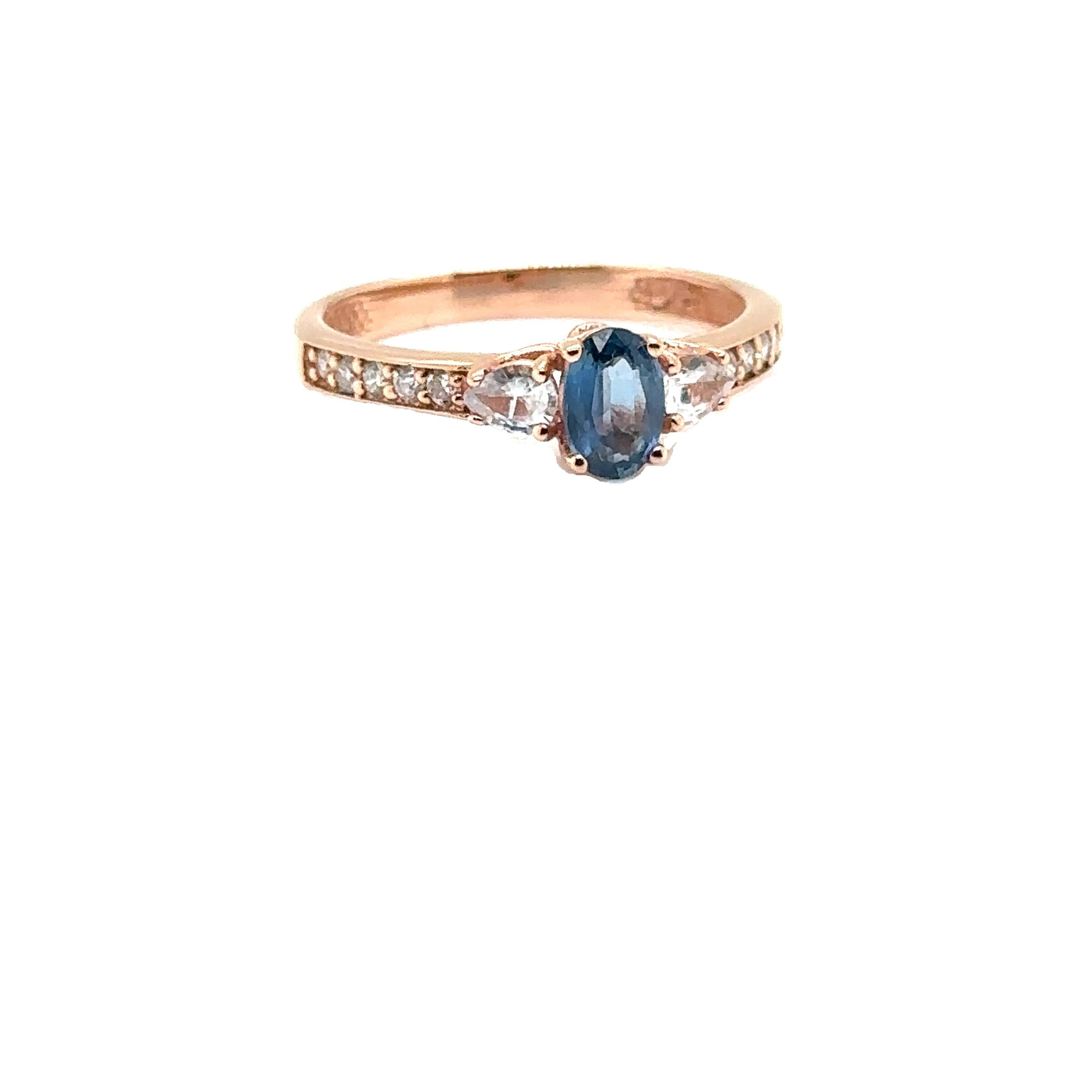 14K ROSE GOLD OVAL SAPPHIRE RING with WHITE SAPPHIRES & DIAMONDS 
Metal: 14K ROSE GOLD
Diamond Info: GH-SI DIAMONDS 0.20CT
Stones Info: 6X4 OVAL SAPPHIRE 0.60CT
       4x3 PEARSHAPE WHITE SAPPHIRES 0.20CT
Total Dia Weight: 0.20 cwt.
Total Stone