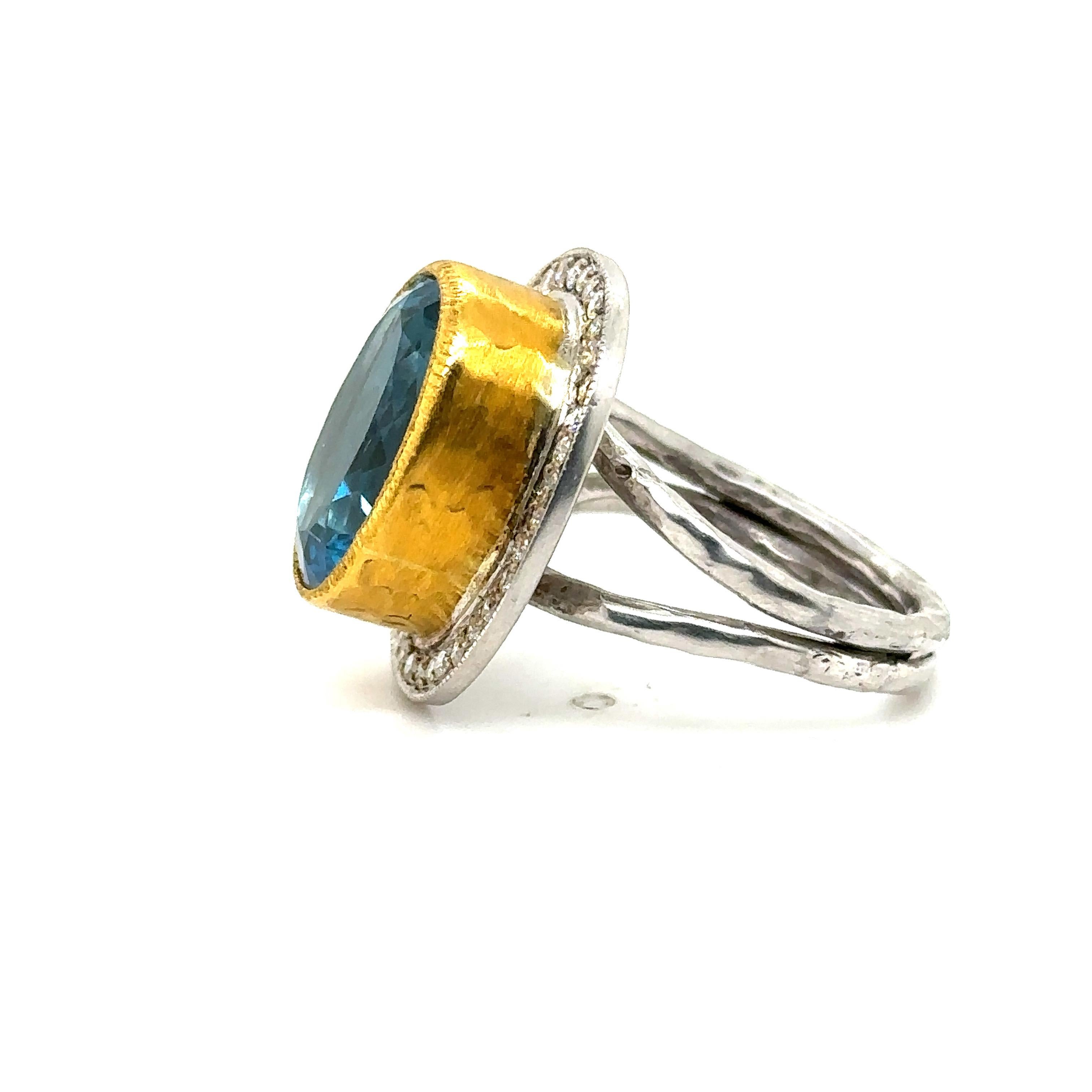 24K GOLD/STERLING SILVER RING with DIAMONDS AND SWISS BLUE TOPAZ 
Metal: 24K GOLD/SS
Diamond Info: I/J COLOR SI1/2 ROUND BRILLIANT 0.52CT
Stone Info: 16X12MM SWISS BLUE TOPAZ 14CT
Total Diamond Weight:  0.52 cwt.
Item Weight: 11.82 gm
Ring Size: 8